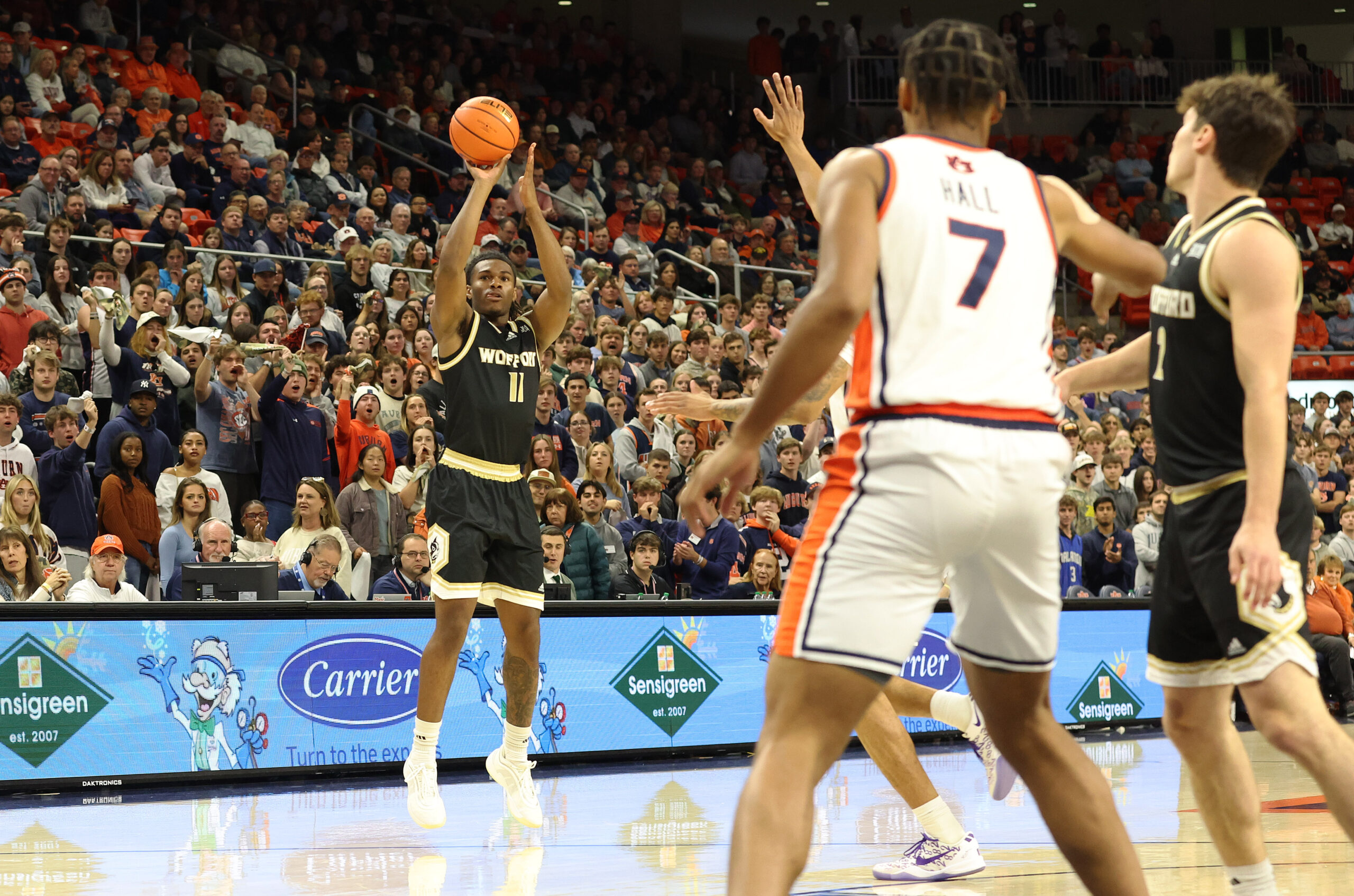 Nov 11, 2025; Auburn, Alabama, USA;  Wofford Terriers guard Kahmare Holmes (11) takes a 3-point shot during the first half against the Auburn Tigers at Neville Arena. Mandatory Credit: John Reed-Imagn Images
