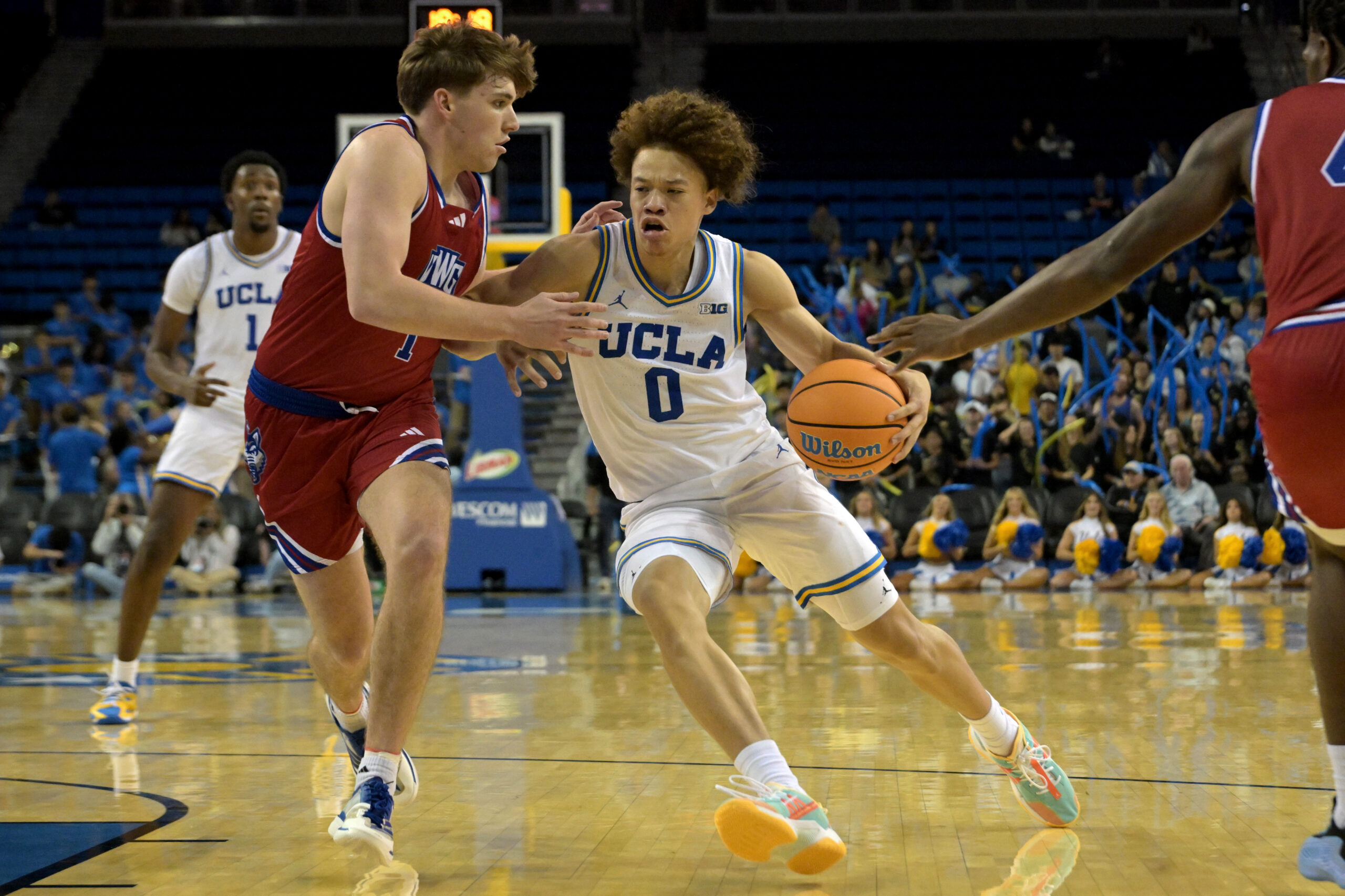 Nov 10, 2025; Los Angeles, California, USA;  UCLA Bruins guard Trent Perry (0) is defended by West Georgia Wolves guard Brady Hardewig (1) during the second half at Pauley Pavilion presented by Wescom Financial. Mandatory Credit: Jayne Kamin-Oncea-Imagn Images