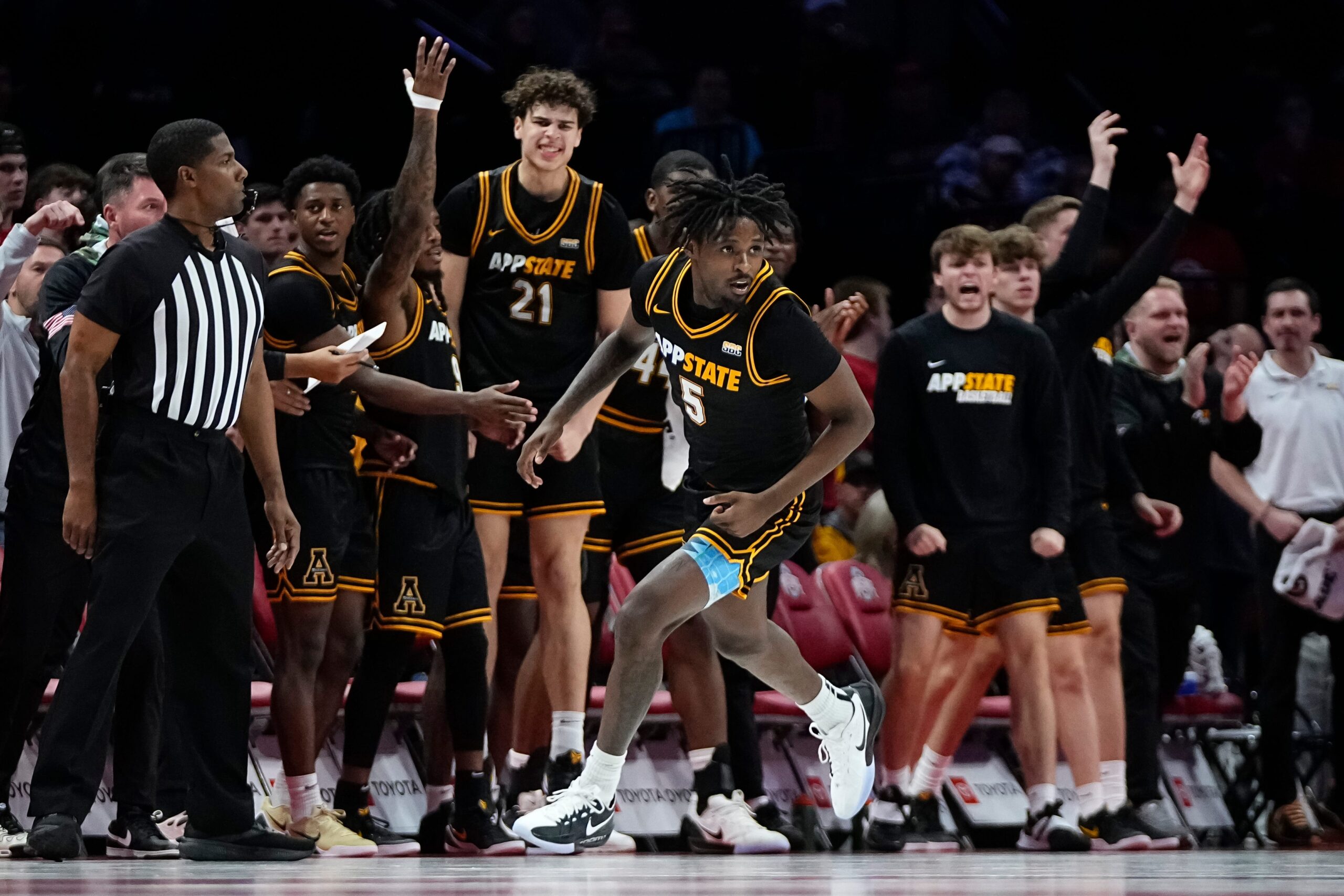 The Appalachian State Mountaineers bench reacts to a shot by guard Jason Clarke Jr. (5) during the NCAA men's basketball game against the Ohio State Buckeyes at Value City Arena in Columbus on Nov. 11, 2025. Ohio State won 75-53.