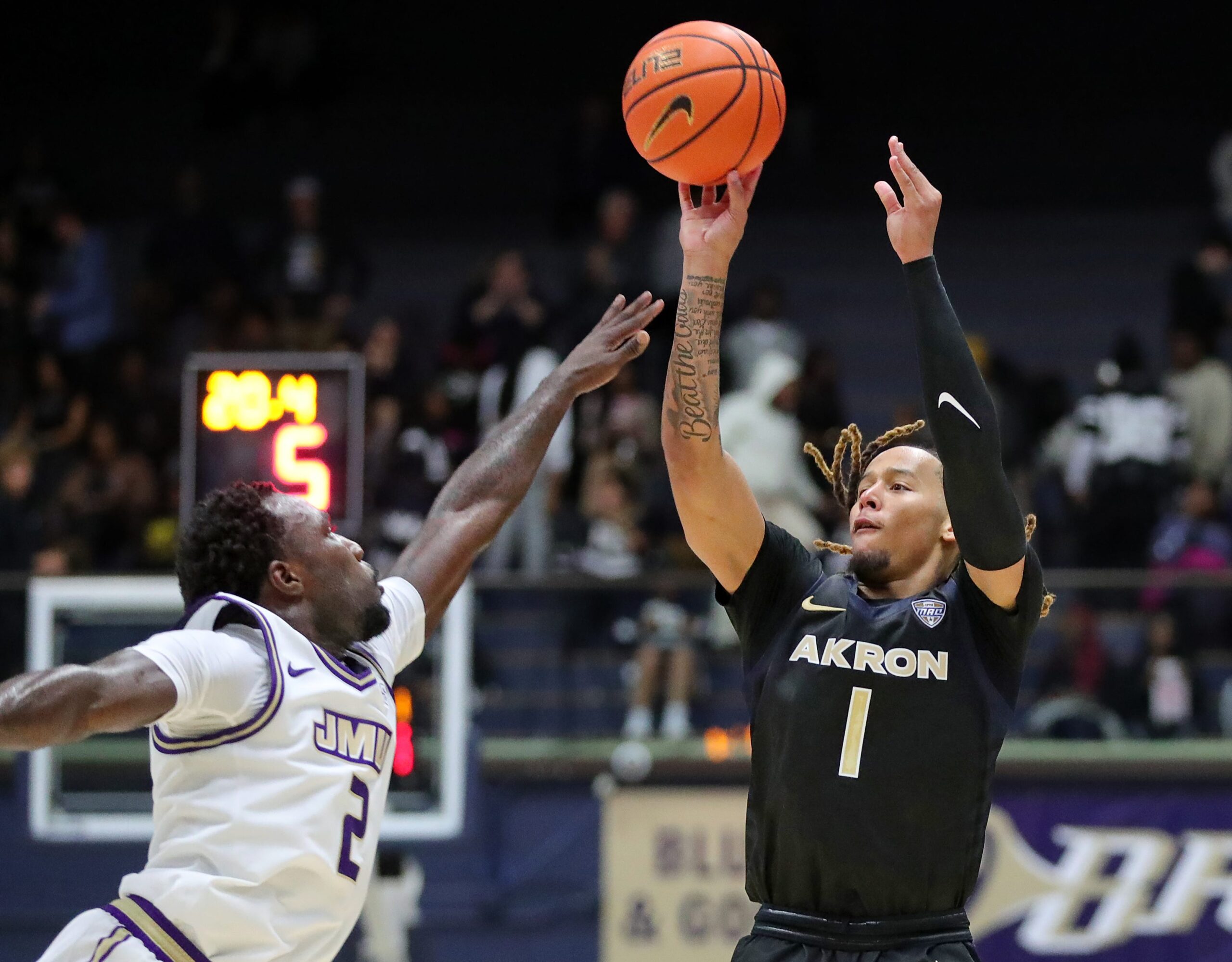 Akron Zips guard Shammah Scott shoots a 3-pointer over James Madison guard Bradley Douglas on Nov. 3, 2025.