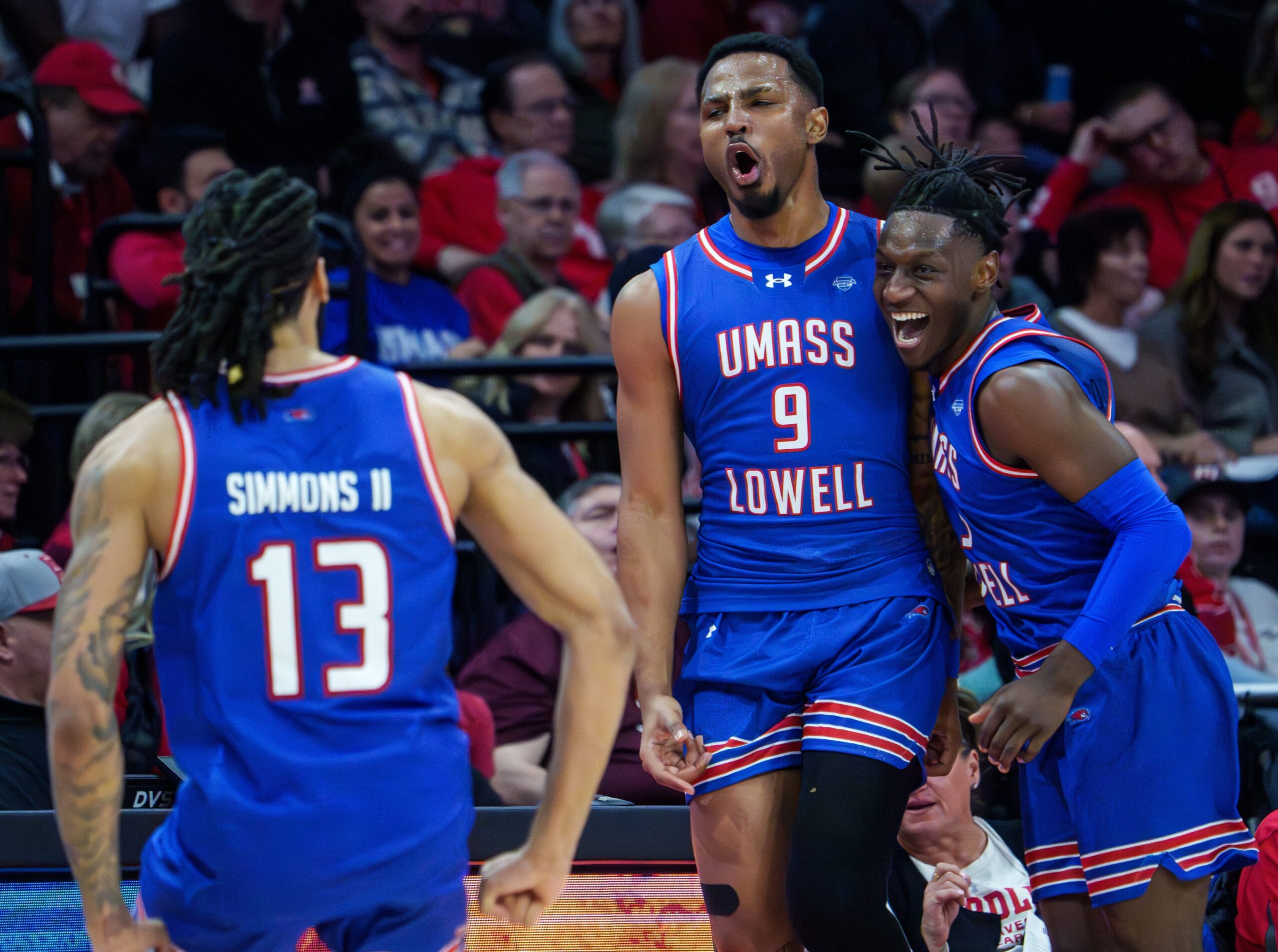 UMass Lowell’s Angel Montas Jr. (9) celebrates his last-second three-pointer against Bradley to end the first half of their college basketball game Wednesday, Nov. 19, 2025 at Carver Arena in Peoria. The Braves rallied to defeat the River Hawks 87-77.