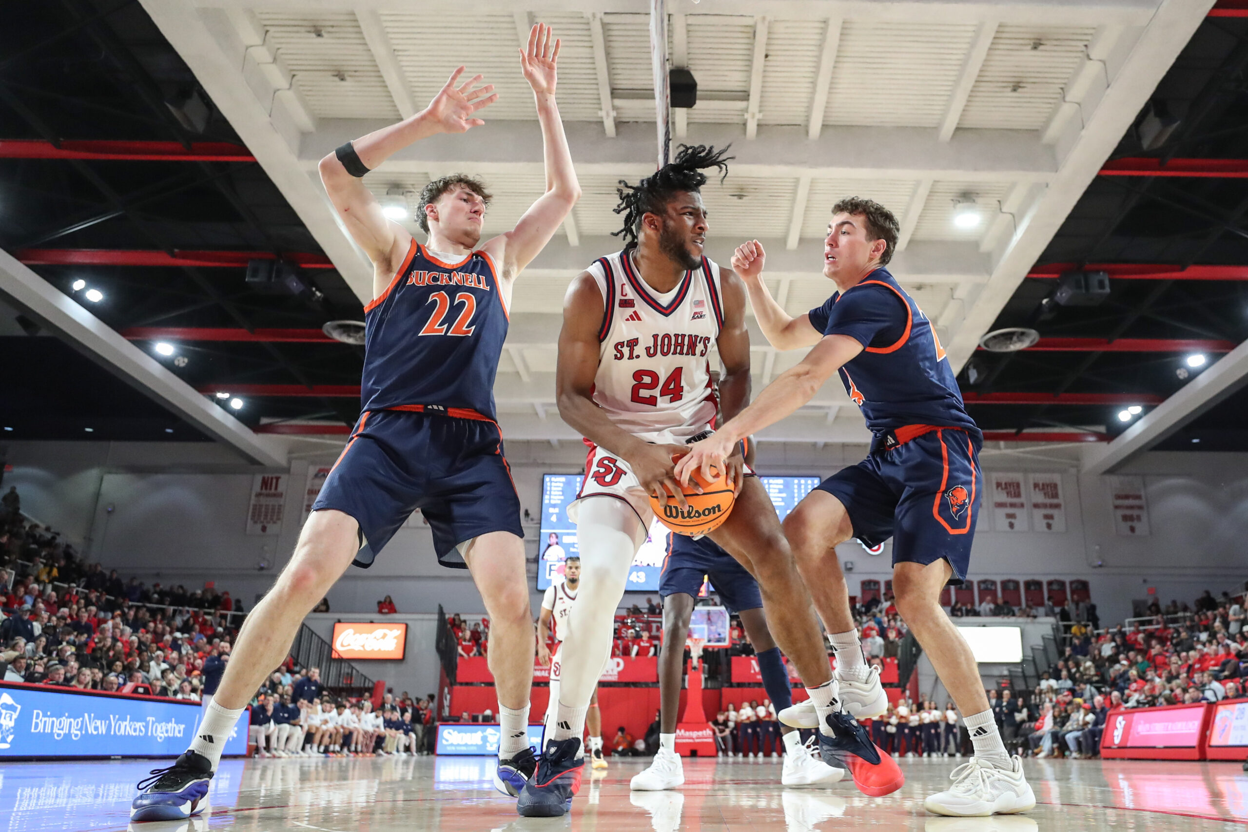 Nov 20, 2025; Queens, New York, USA;  St. John's Red Storm forward Zuby Ejiofor (24) is double teammed by Bucknell Bison forward Amon Dörries (22) and guard Achile Spadone (24) in the second half at Carnesecca Arena. Mandatory Credit: Wendell Cruz-Imagn Images