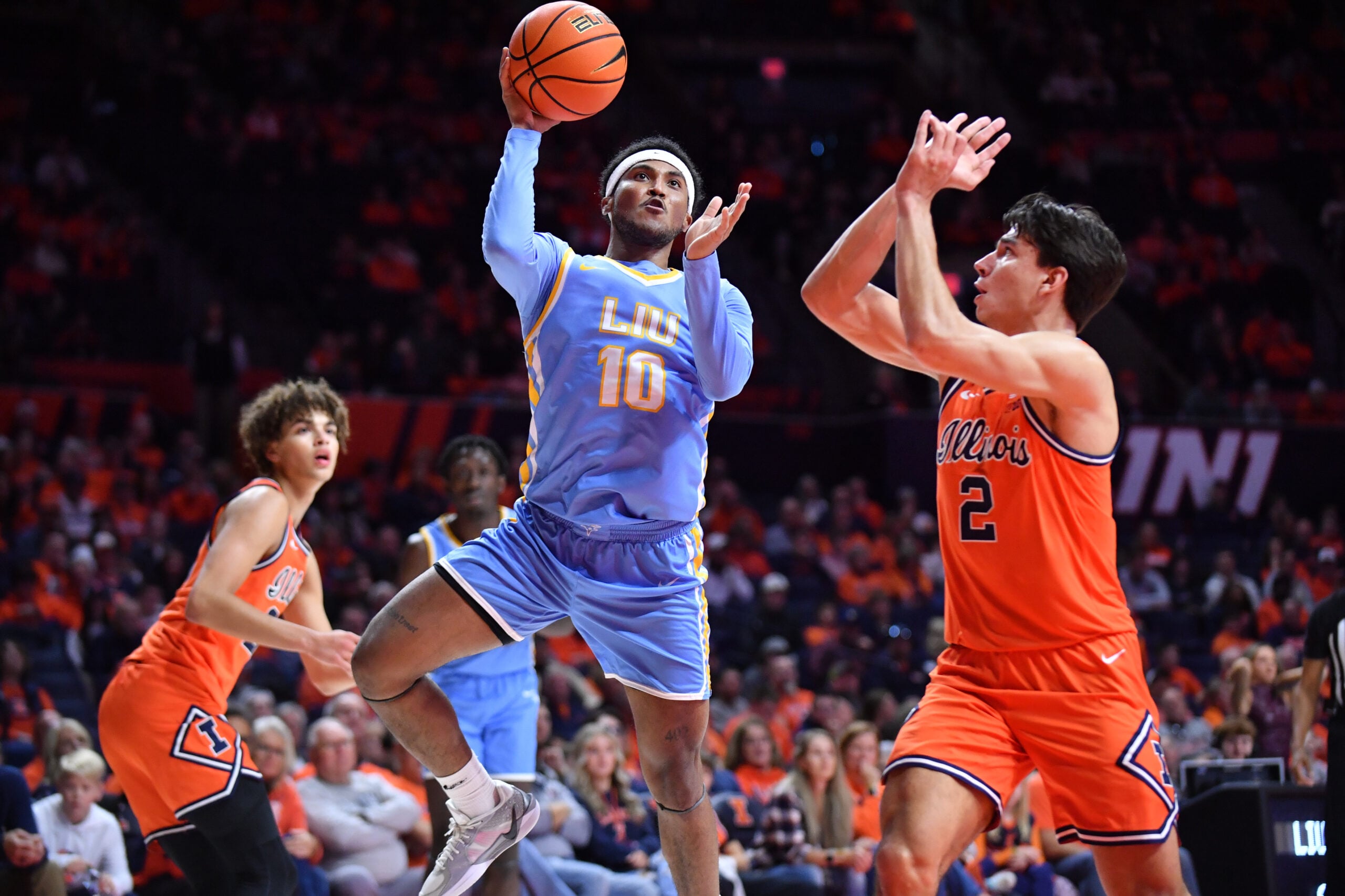 Nov 22, 2025; Champaign, Illinois, USA;  Long Island University Sharks guard A.J. Neal, Jr. (10) drives to the basket as Illinois Fighting Illini guard Andrej Stojakovic (2) defends during the second half at State Farm Center. Mandatory Credit: Ron Johnson-Imagn Images