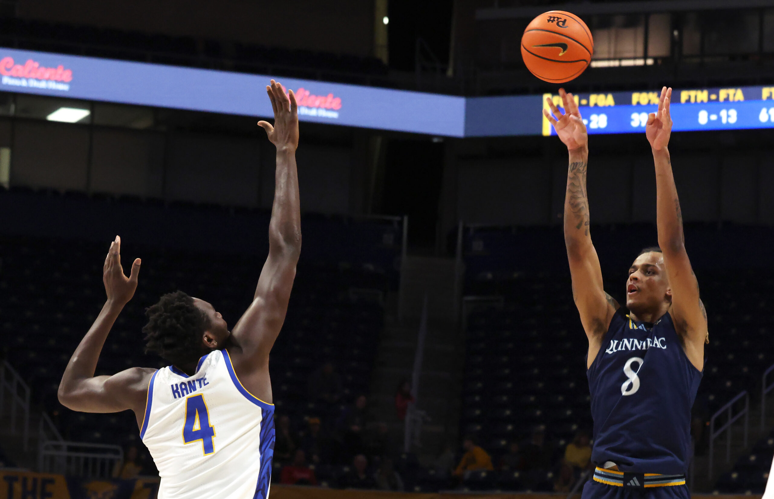 Nov 23, 2025; Pittsburgh, Pennsylvania, USA;  Quinnipiac Bobcats forward Grant Randall (8) shoots against Pittsburgh Panthers forward Papa Amadou Kante (4) during the second half at the Petersen Events Center. Mandatory Credit: Charles LeClaire-Imagn Images