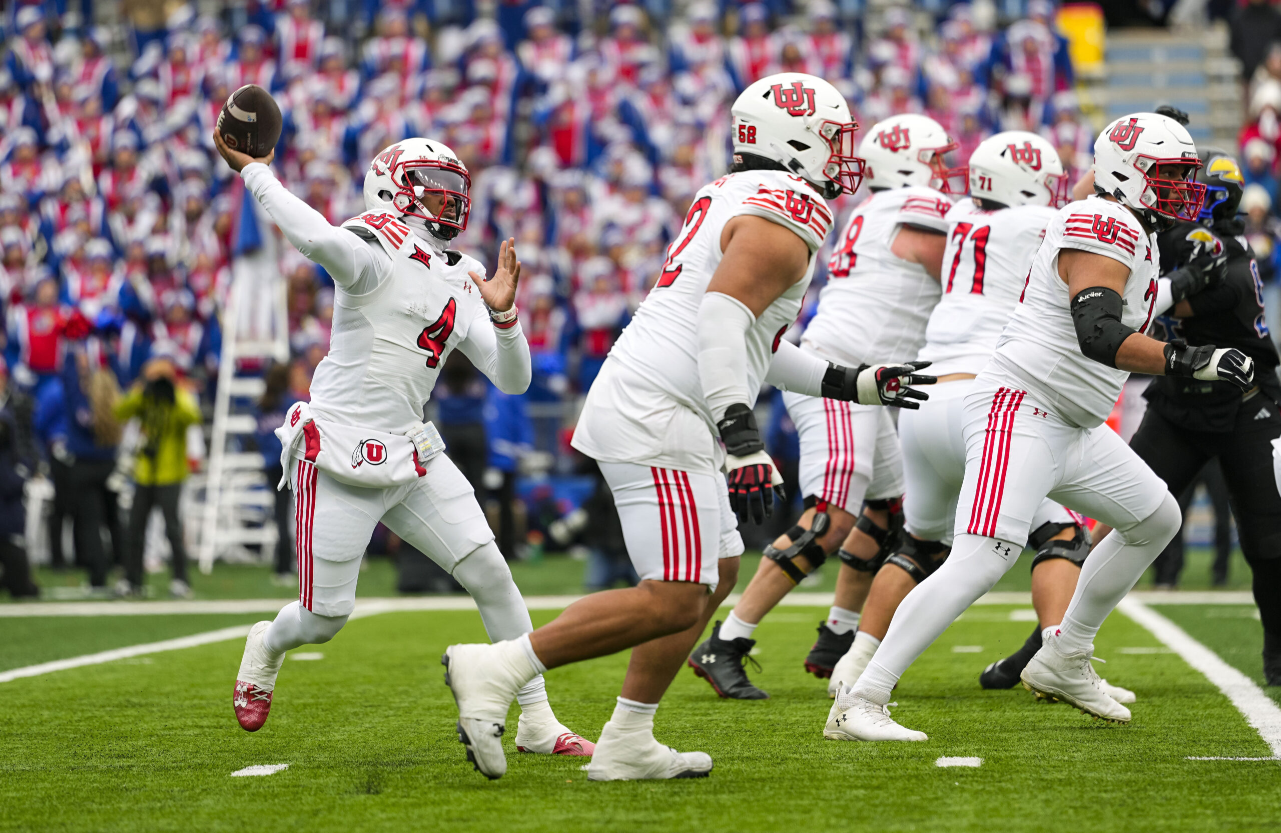 Nov 28, 2025; Lawrence, Kansas, USA; Utah Utes quarterback Devon Dampier (4) throws a pass during the first half against the Kansas Jayhawks at David Booth Kansas Memorial Stadium. Mandatory Credit: Jay Biggerstaff-Imagn Images
