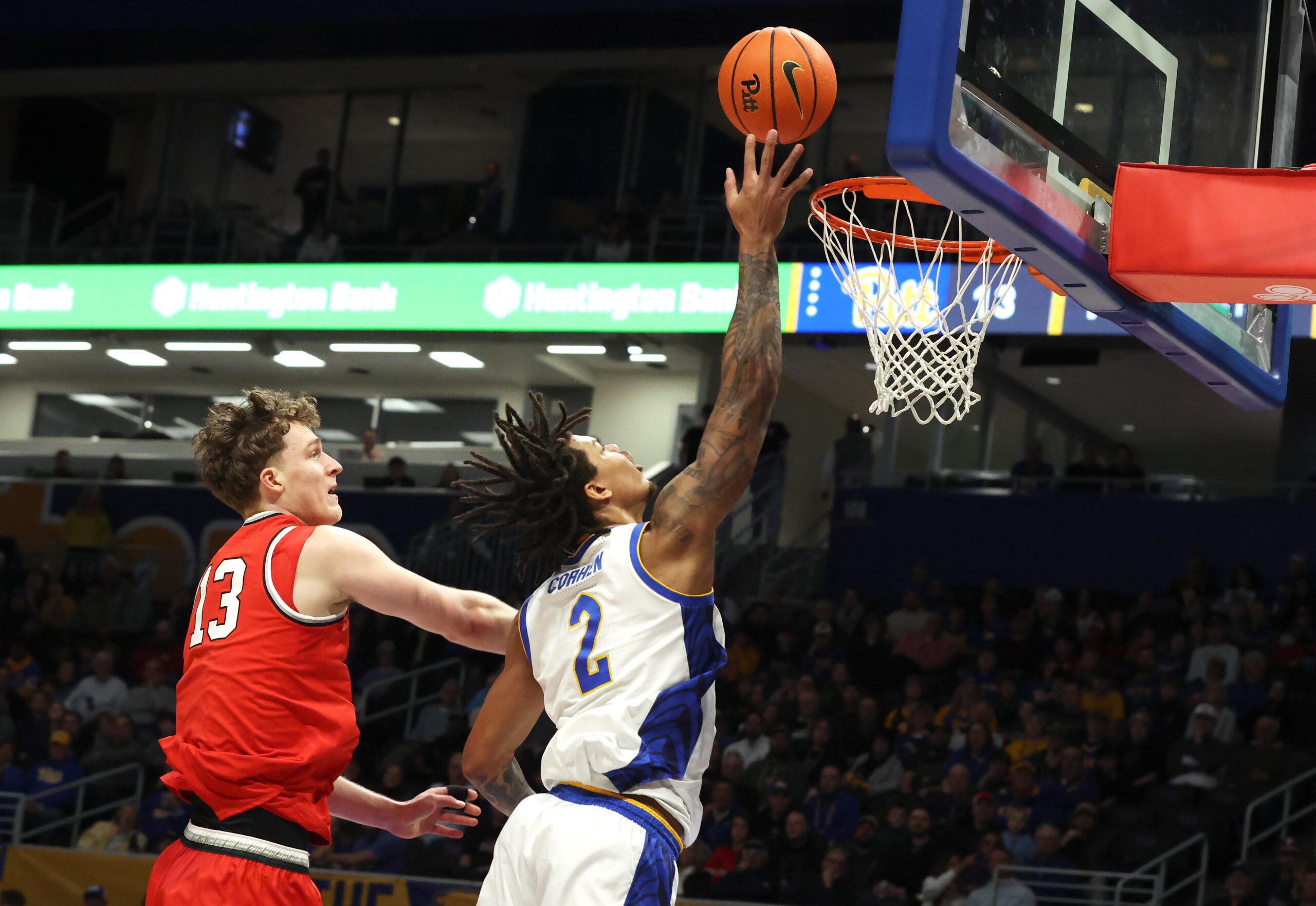 Nov 28, 2025; Pittsburgh, Pennsylvania, USA;  Pittsburgh Panthers forward Cameron Corhen (2) shoots against Ohio State Buckeyes center Christoph Tilly (13) during the first half at the Petersen Events Center. Mandatory Credit: Charles LeClaire-Imagn Images
