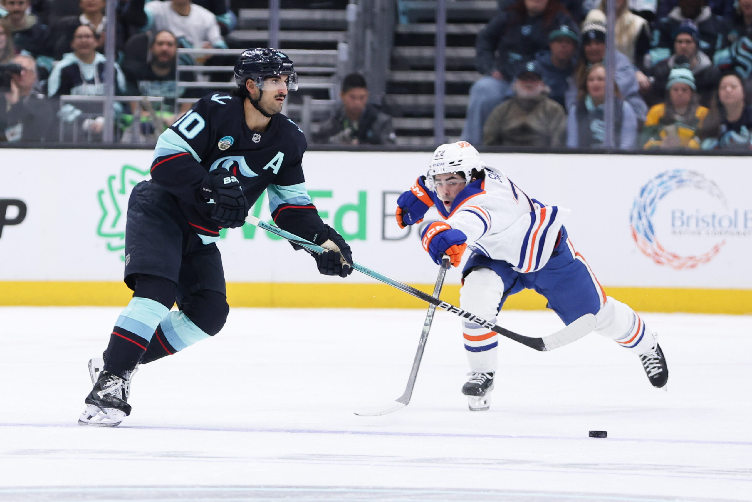 Nov 29, 2025; Seattle, Washington, USA;  Seattle Kraken center Matty Beniers (10) passes the puck in the first period against the Edmonton Oilers at Climate Pledge Arena. Mandatory Credit: Kevin Ng-Imagn Images