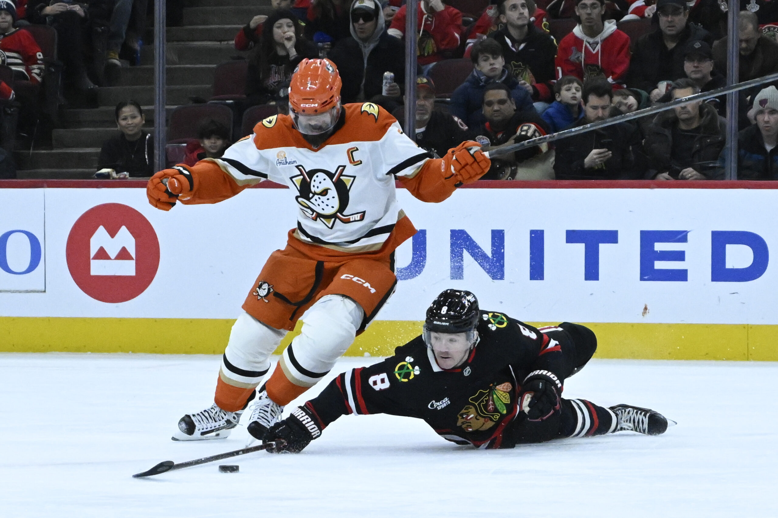 Nov 30, 2025; Chicago, Illinois, USA;  Anaheim Ducks defenseman Radko Gudas (7) and Chicago Blackhawks center Ryan Donato (8) chase the puck during the first period at United Center. Mandatory Credit: Matt Marton-Imagn Images