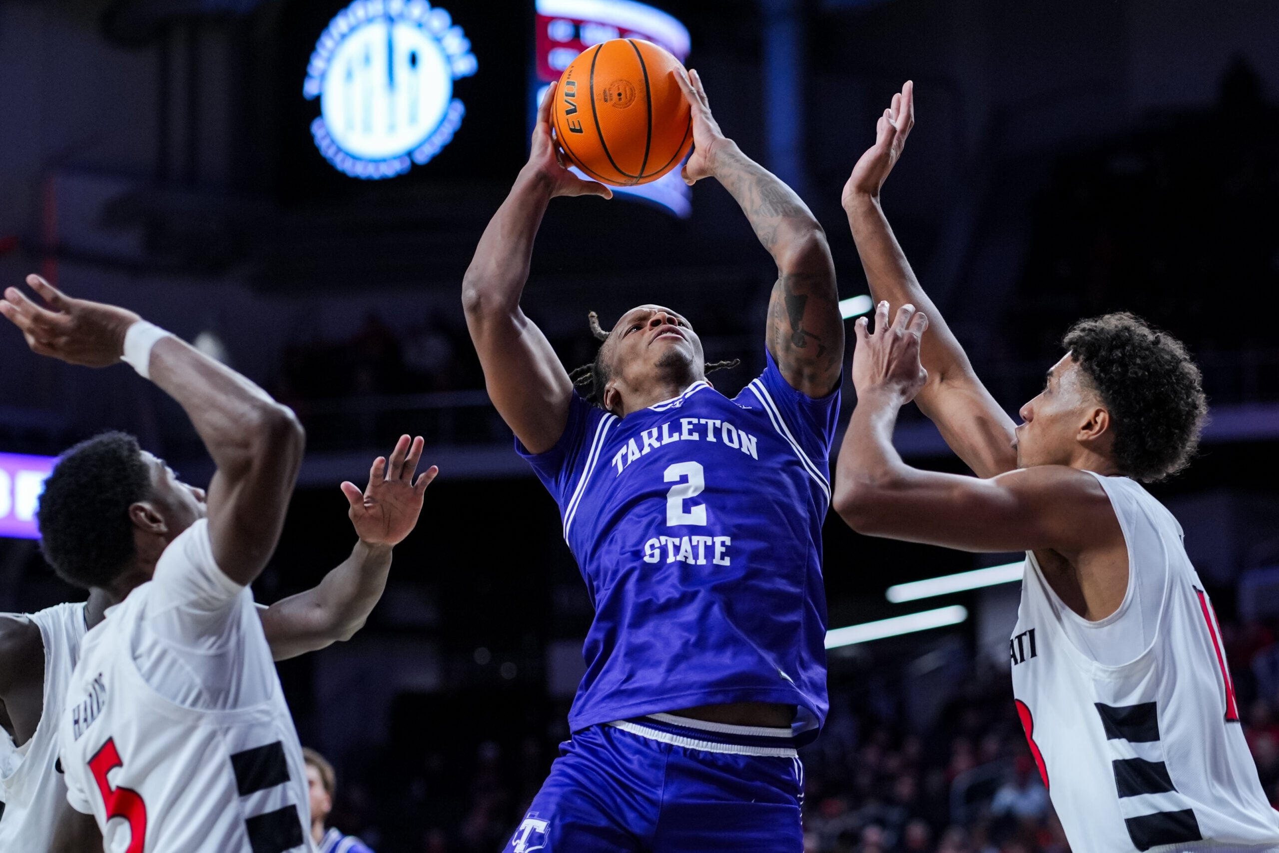 Dec 1, 2025; Cincinnati, Ohio, USA;  Tarleton State Texans guard Freddy Hicks (2) drives to the basket against Cincinnati Bearcats forward Baba Miller (18) in the second half at Fifth Third Arena. Mandatory Credit: Aaron Doster-Imagn Images