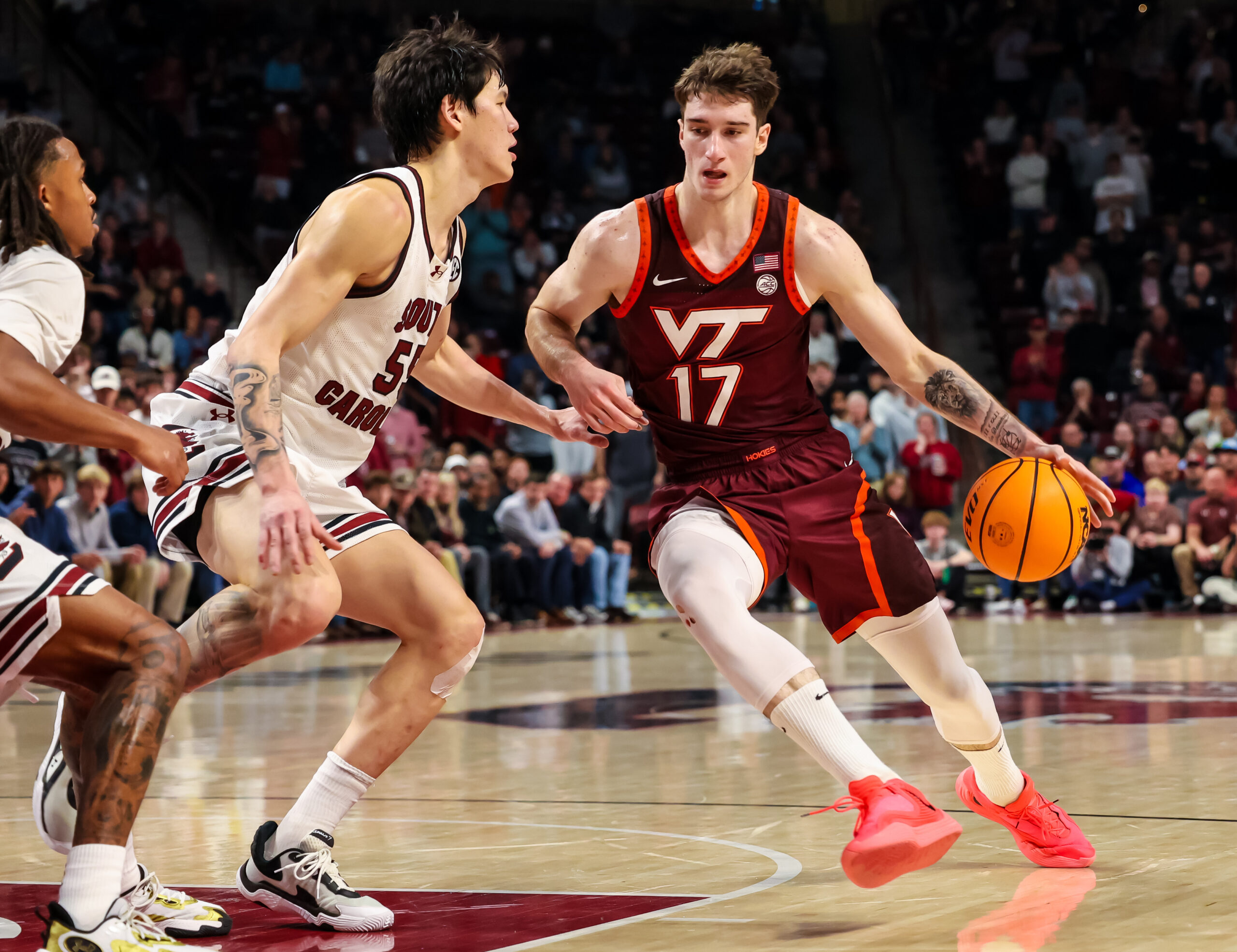 Dec 2, 2025; Columbia, South Carolina, USA; Virginia Tech Hokies guard Neoklis Avdalas (17) drives around South Carolina Gamecocks guard Mike Sharavjamts (55) in the second half at Colonial Life Arena. Mandatory Credit: Jeff Blake-Imagn Images