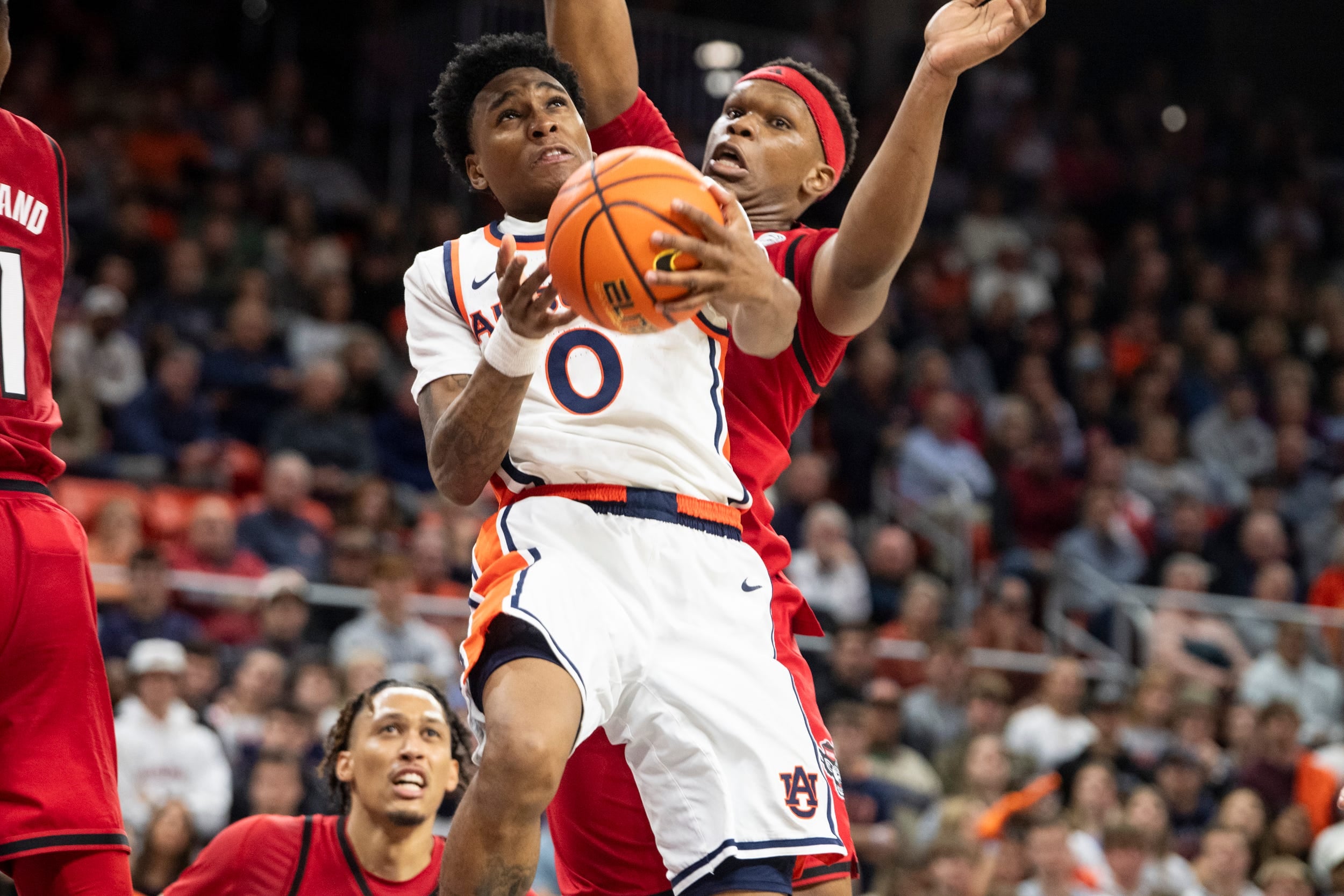 Auburn Tigers guard Tahaad Pettiford (0) goes up for a layup as Auburn Tigers take on NC State Wolfpack at Neville Arena in Auburn, Ala. on Wednesday, Dec. 3, 2025. Auburn Tigers defeated NC State Wolfpack 83-73.