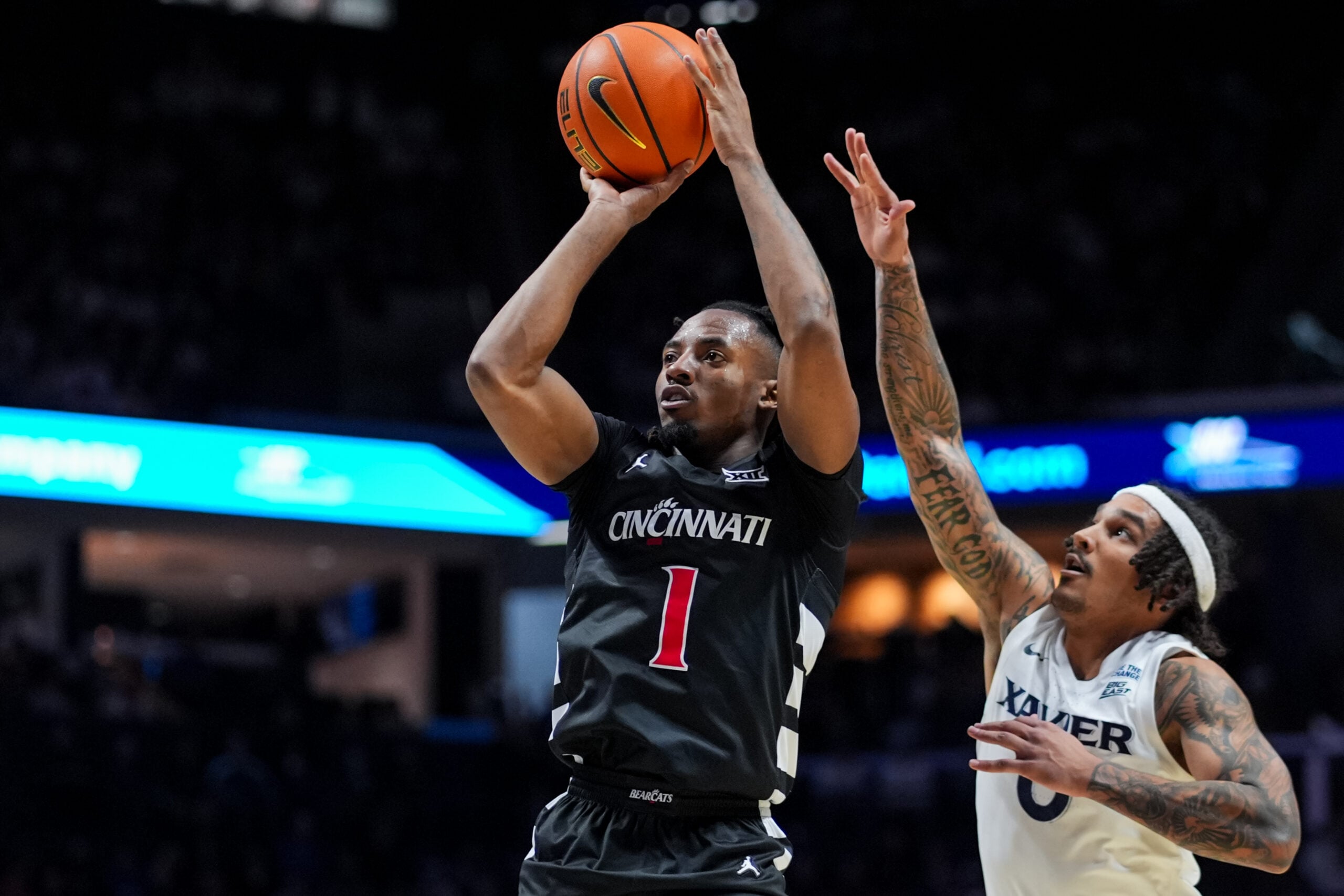 Dec 5, 2025; Cincinnati, Ohio, USA;  Cincinnati Bearcats guard Day Day Thomas (1) shoots against Xavier Musketeers guard Roddie Anderson III (0) in the second half at the Cintas Center. Mandatory Credit: Aaron Doster-Imagn Images