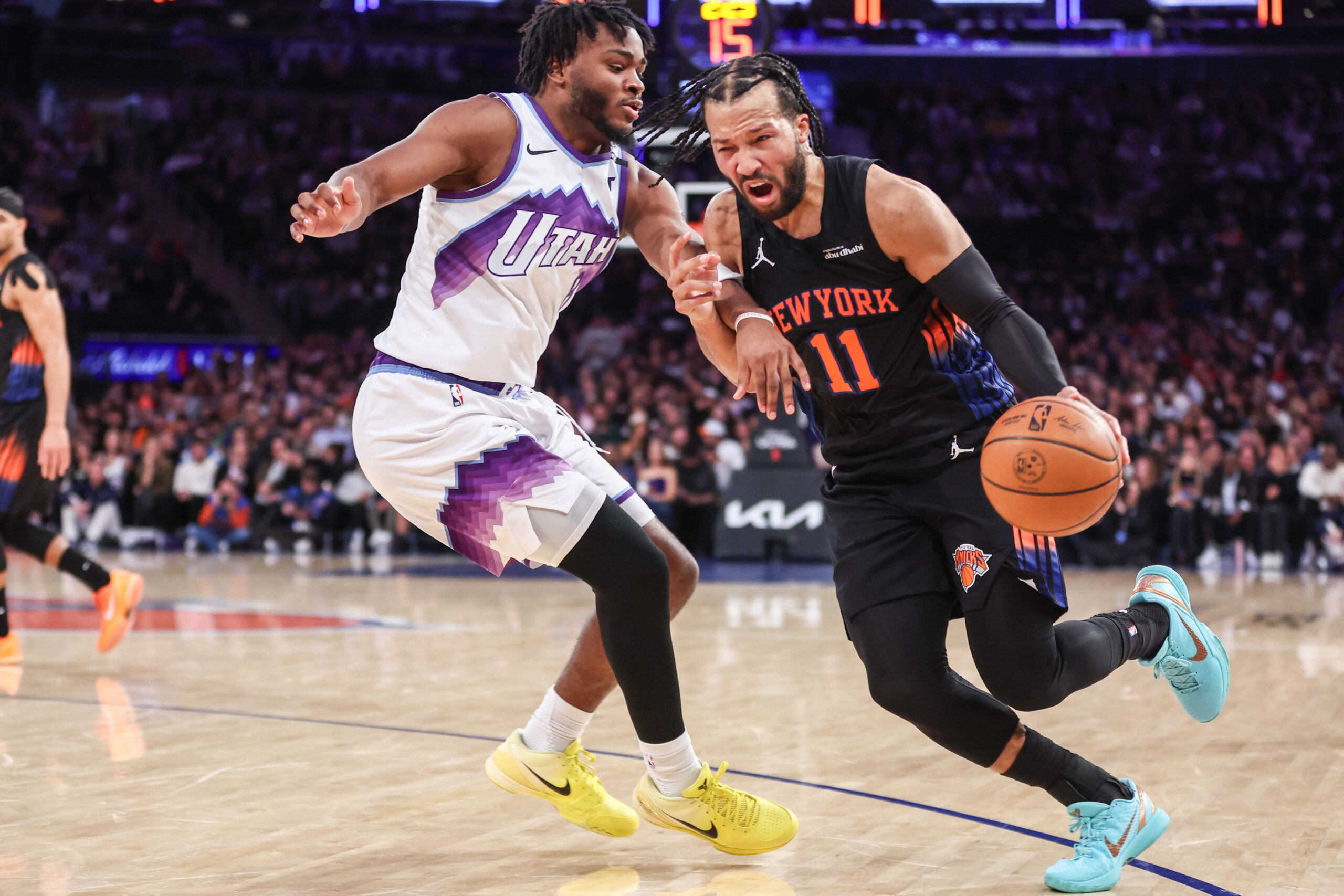Dec 5, 2025; New York, New York, USA;  New York Knicks guard Jalen Brunson (11) looks to drive past Utah Jazz guard Isaiah Collier (8) in the third quarter at Madison Square Garden. Mandatory Credit: Wendell Cruz-Imagn Images
