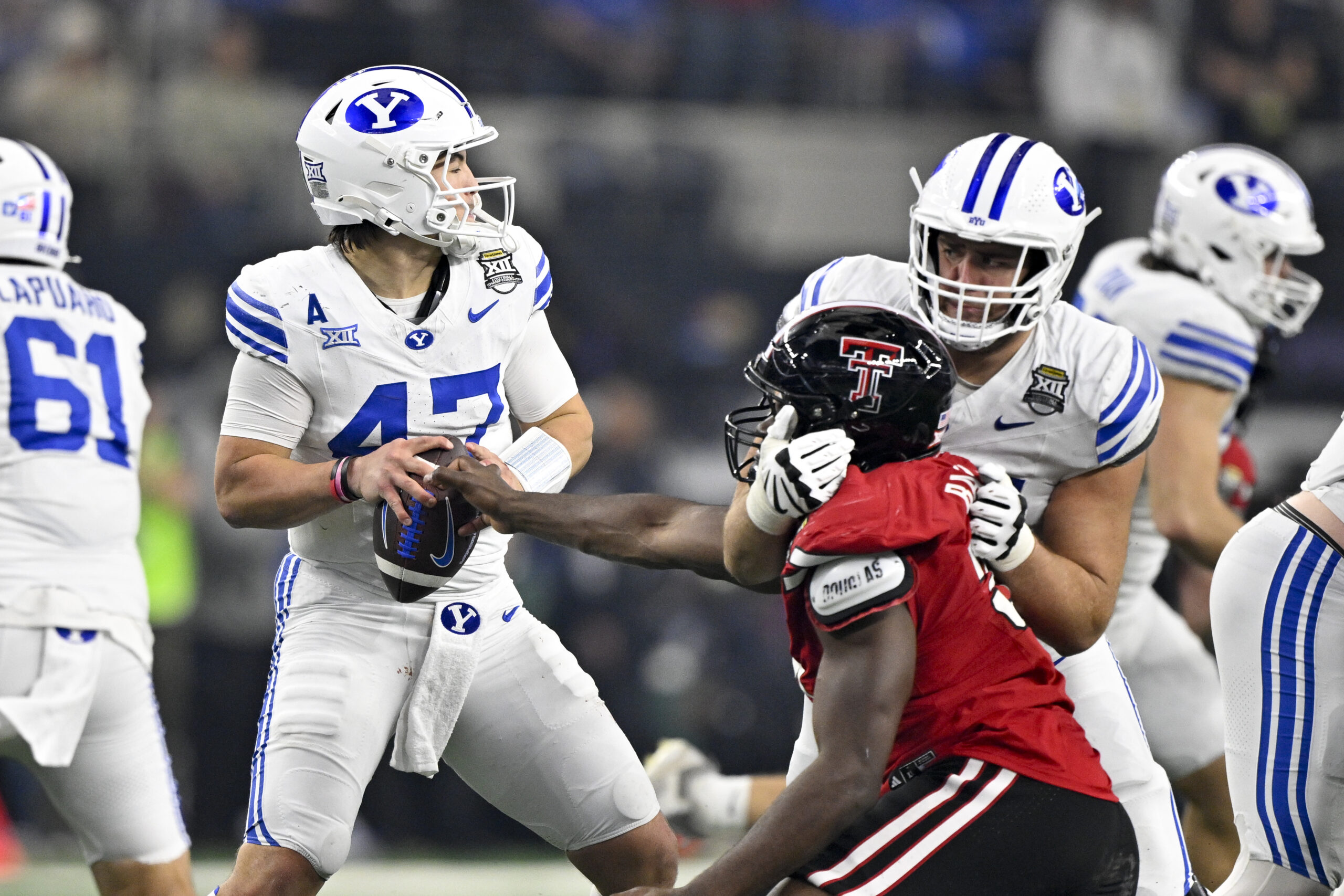 Dec 6, 2025; Arlington, TX, USA; Texas Tech Red Raiders defensive back Miquel Dingle Jr. (21) strips the ball away from BYU Cougars quarterback Bear Bachmeier (47) during the second half at AT&T Stadium. Mandatory Credit: Jerome Miron-Imagn Images