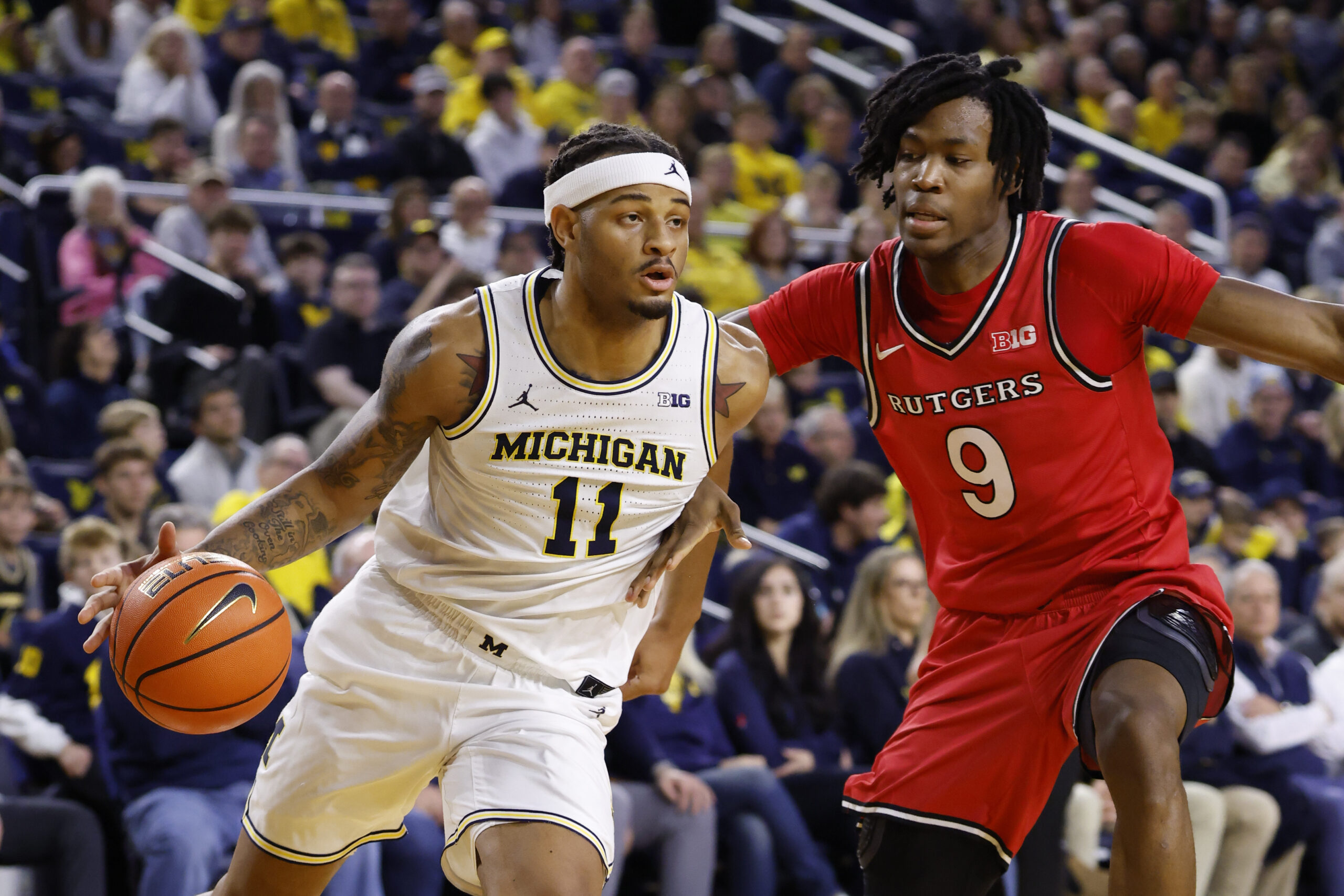 Dec 6, 2025; Ann Arbor, Michigan, USA;  Michigan Wolverines guard Roddy Gayle Jr. (11) dribbles defended by Rutgers Scarlet Knights forward Dylan Grant (9) in the first half at Crisler Center. Mandatory Credit: Rick Osentoski-Imagn Images