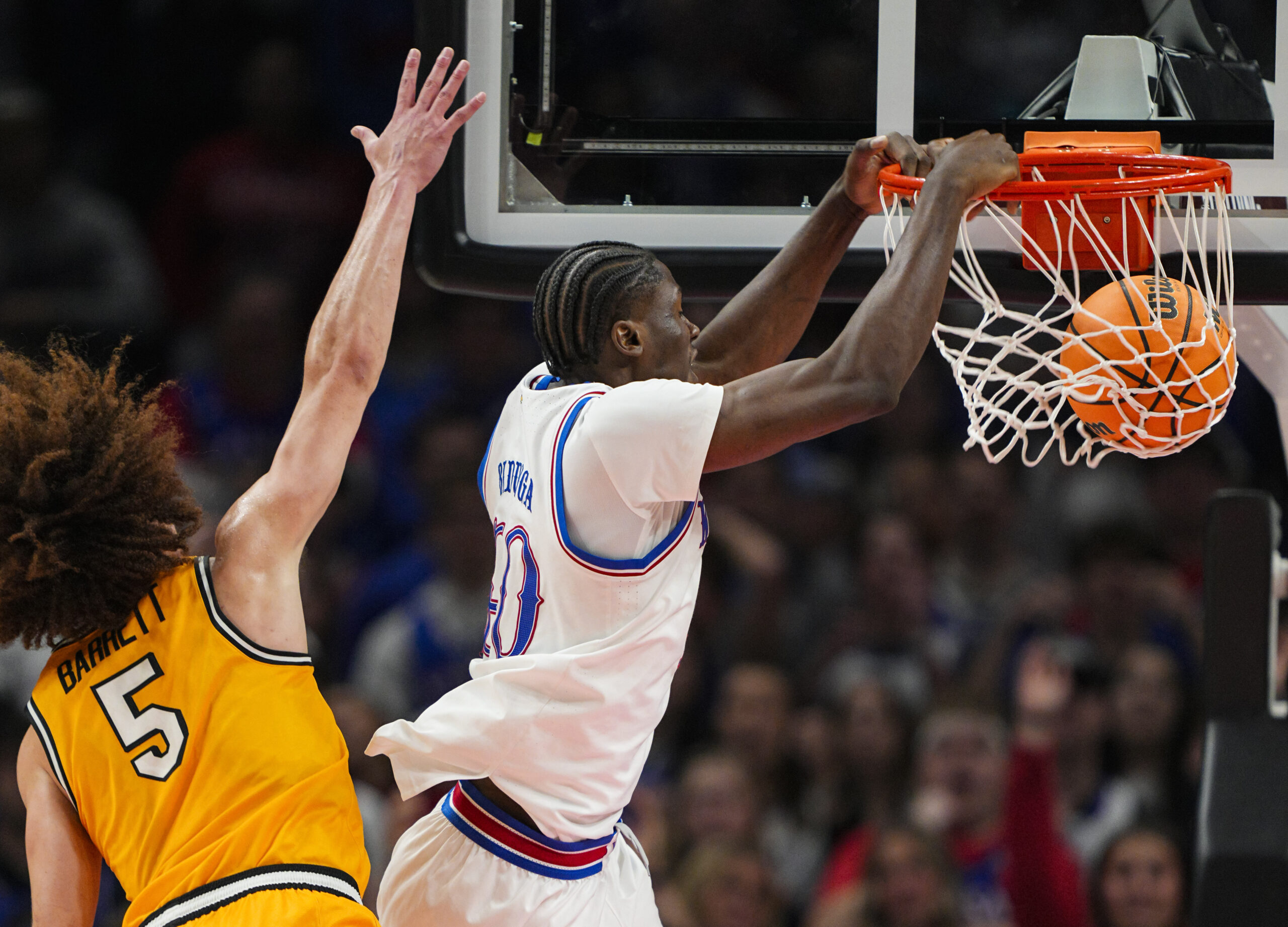Dec 7, 2025; Kansas City, Missouri, USA; Kansas Jayhawks forward Flory Bidunga (40) dunks the ball against Missouri Tigers guard T.O. Barrett (5) during the second half at T-Mobile Center. Mandatory Credit: Jay Biggerstaff-Imagn Images