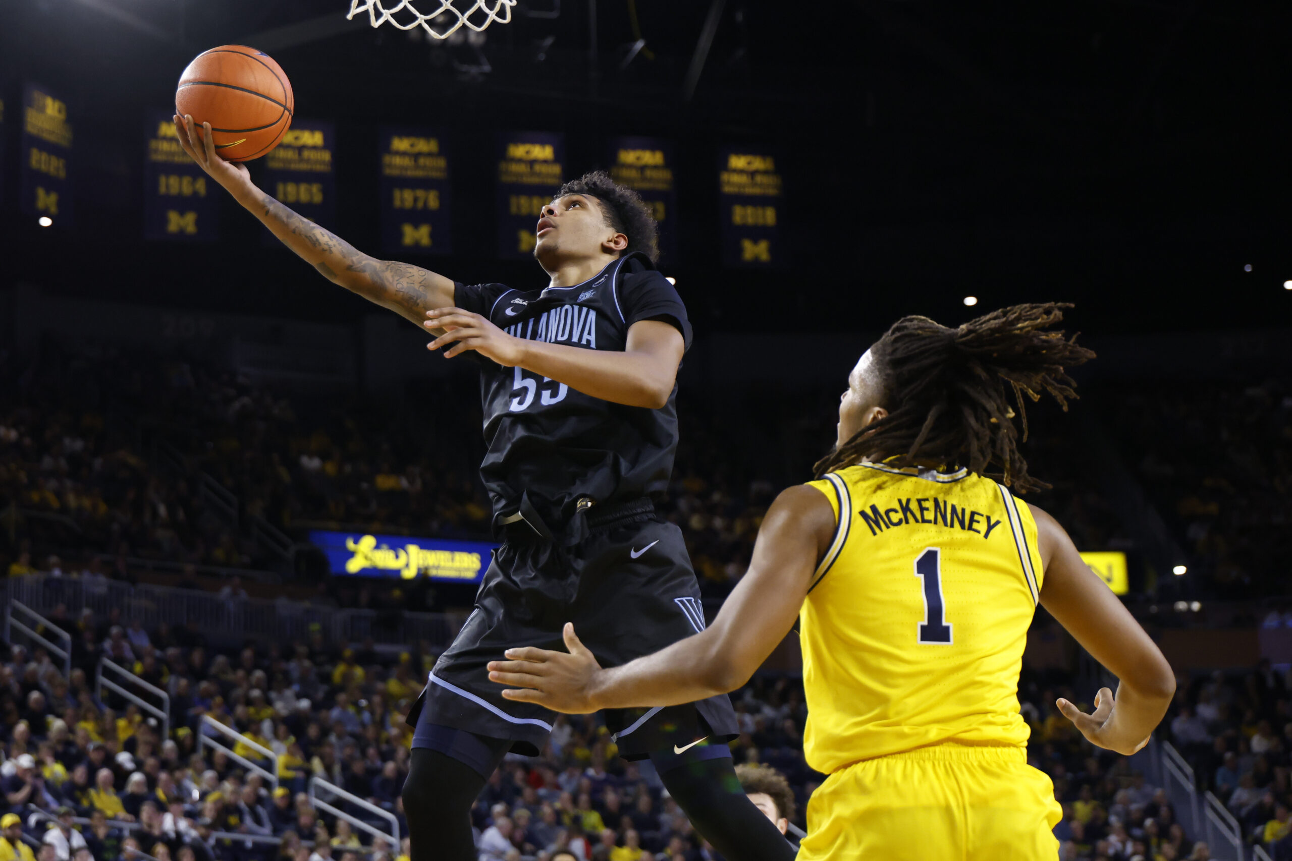 Dec 9, 2025; Ann Arbor, Michigan, USA;  Villanova Wildcats guard Acaden Lewis (55) shoots on Michigan Wolverines guard Trey McKenney (1) in the second half at Crisler Center. Mandatory Credit: Rick Osentoski-Imagn Images