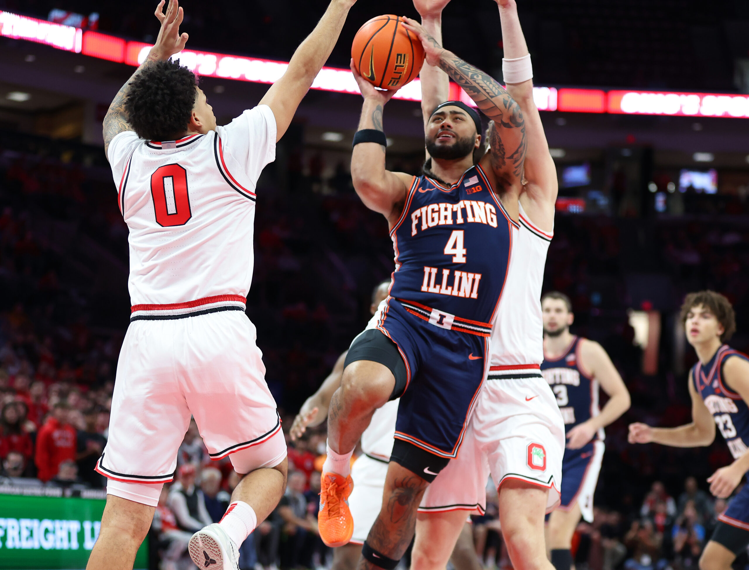 Dec 9, 2025; Columbus, Ohio, USA;  Illinois Fighting Illini guard Kylan Boswell (4) drives to the basket as Ohio State Buckeyes guard John Mobley Jr. (0) defends during the first half Value City Arena. Mandatory Credit: Joseph Maiorana-Imagn Images