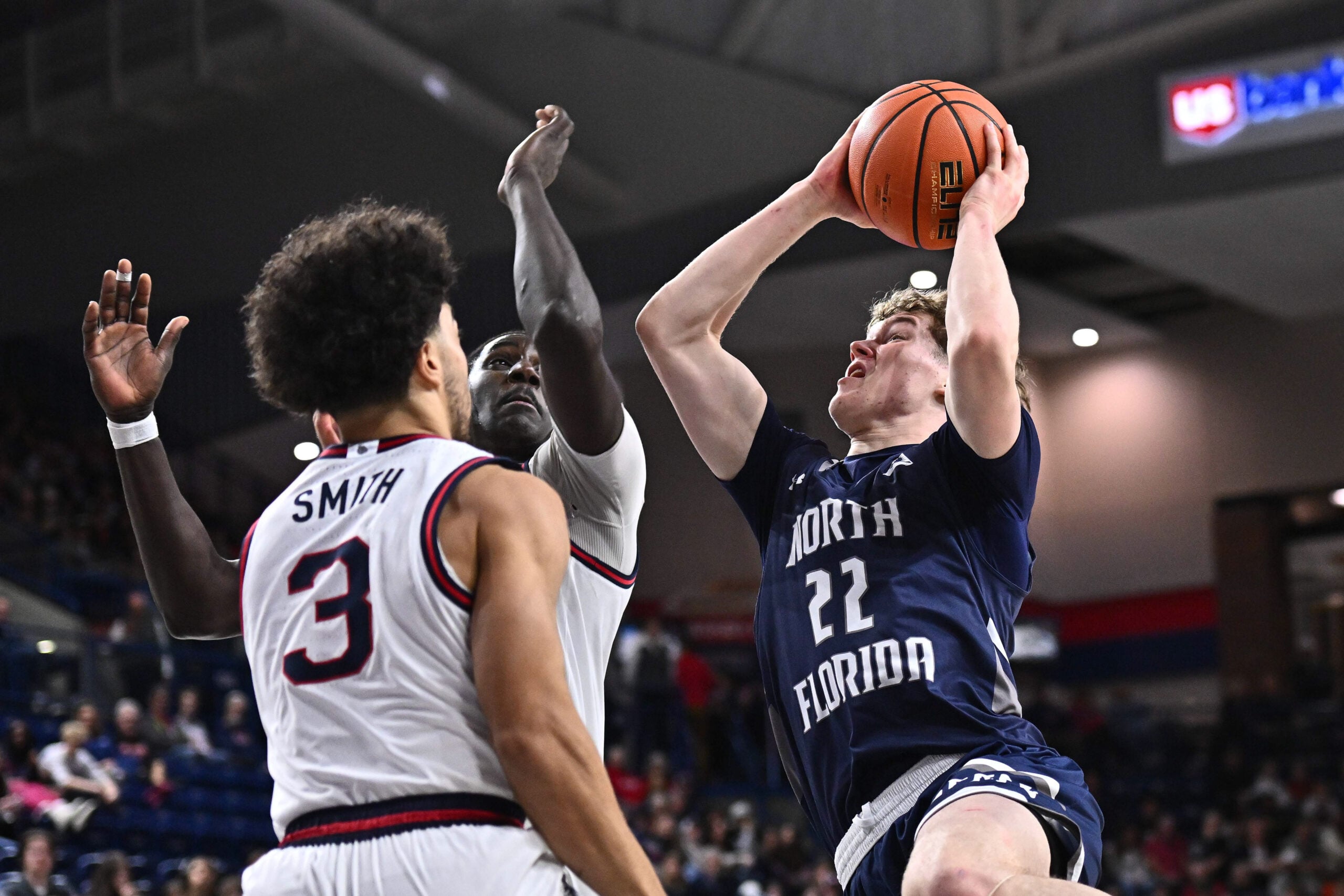 Dec 7, 2025; Spokane, Washington, USA; North Florida Ospreys forward Trey Cady (22) shoots the ball against Gonzaga Bulldogs center Ismaila Diagne (24) in the second half at McCarthey Athletic Center. Mandatory Credit: James Snook-Imagn Images
