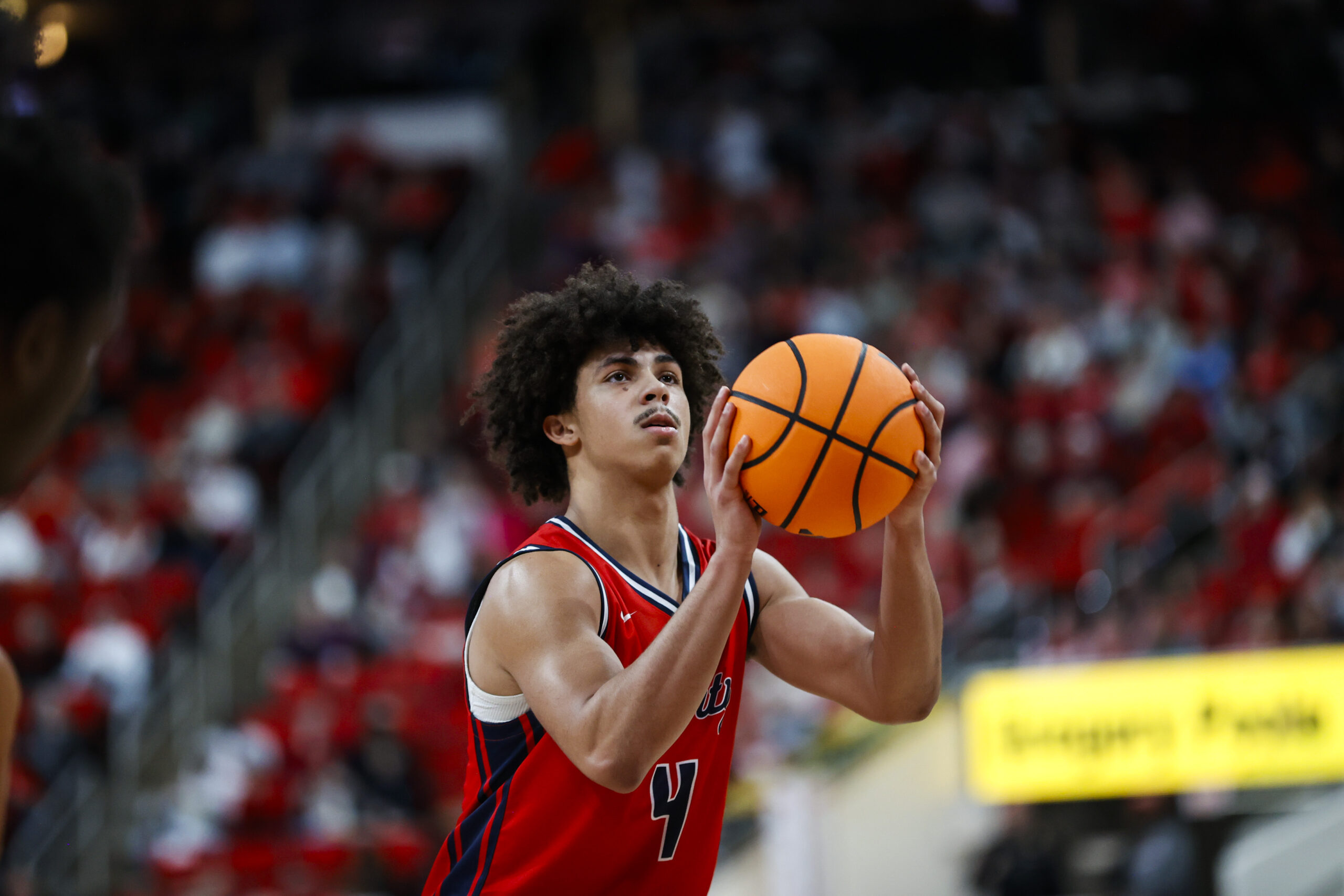 Dec 6, 2025; Raleigh, North Carolina, USA; Liberty Flames guard Brett Decker Jr. (4) shoots a free throw during the second half of the game against the NC State Wolfpack at Lenovo Center. Mandatory Credit: Jaylynn Nash-Imagn Images