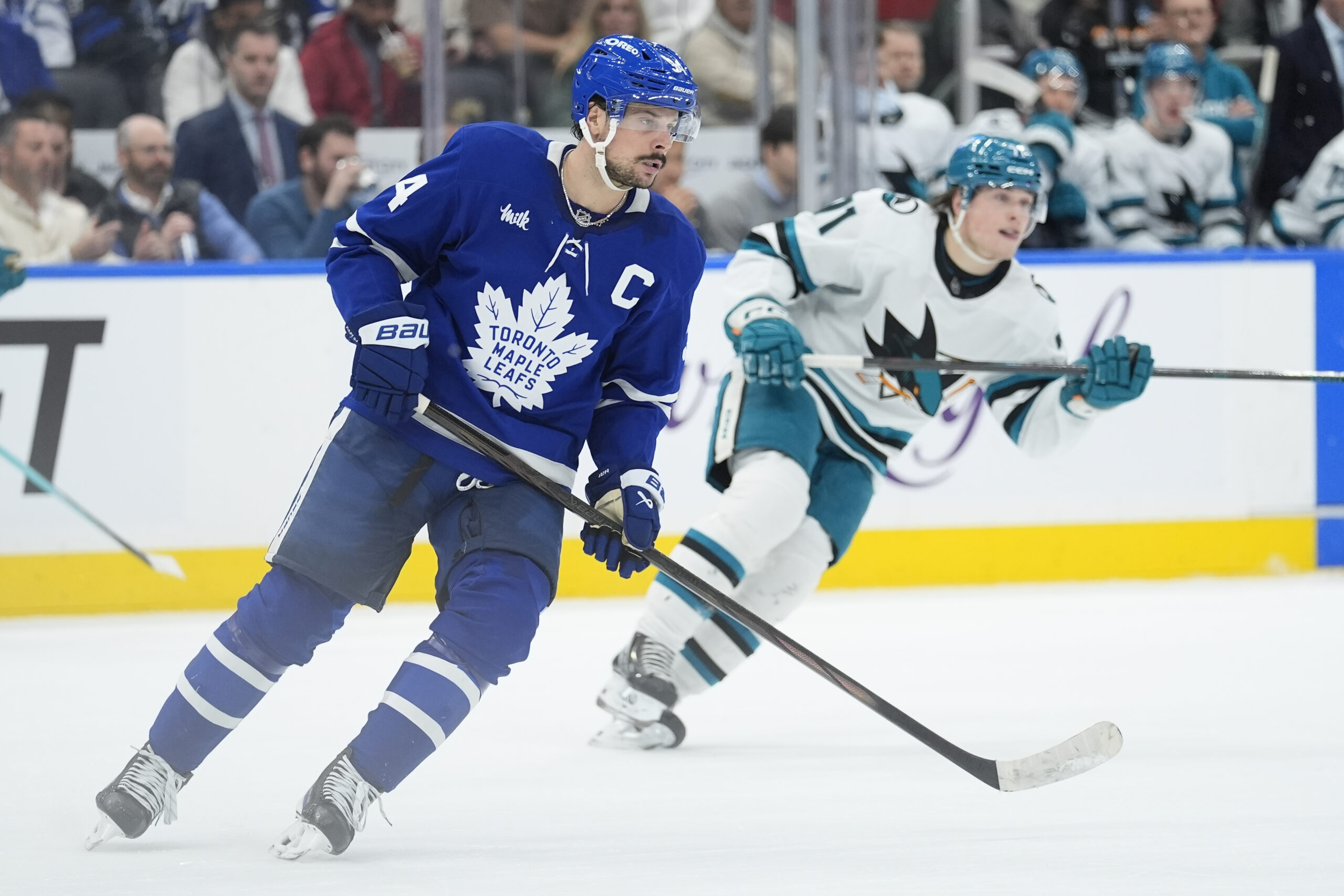 Dec 11, 2025; Toronto, Ontario, CAN; Toronto Maple Leafs forward Auston Matthews (34) and San Jose Sharks forward Macklin Celebrini (71) skate after the puck during the second period at Scotiabank Arena. Mandatory Credit: John E. Sokolowski-Imagn Images