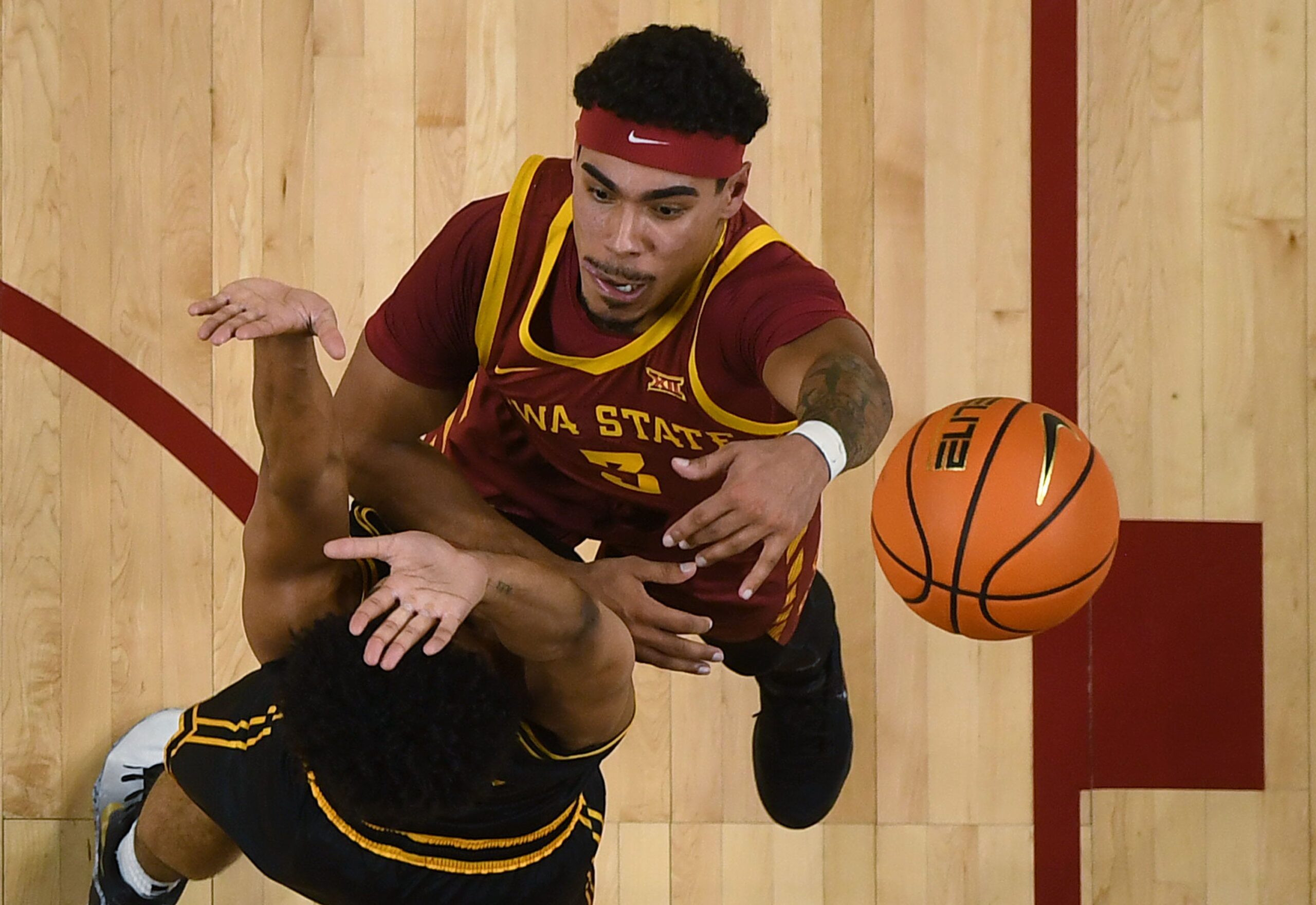 Iowa State Cyclones guard Tamin Lipsey (3) shoots the ball over Iowa Hawkeyes guard Kael Combs (11) during the first half in the men’s basketball Cy-Hawk series on Dec. 11, 2025, in Ames, Iowa.