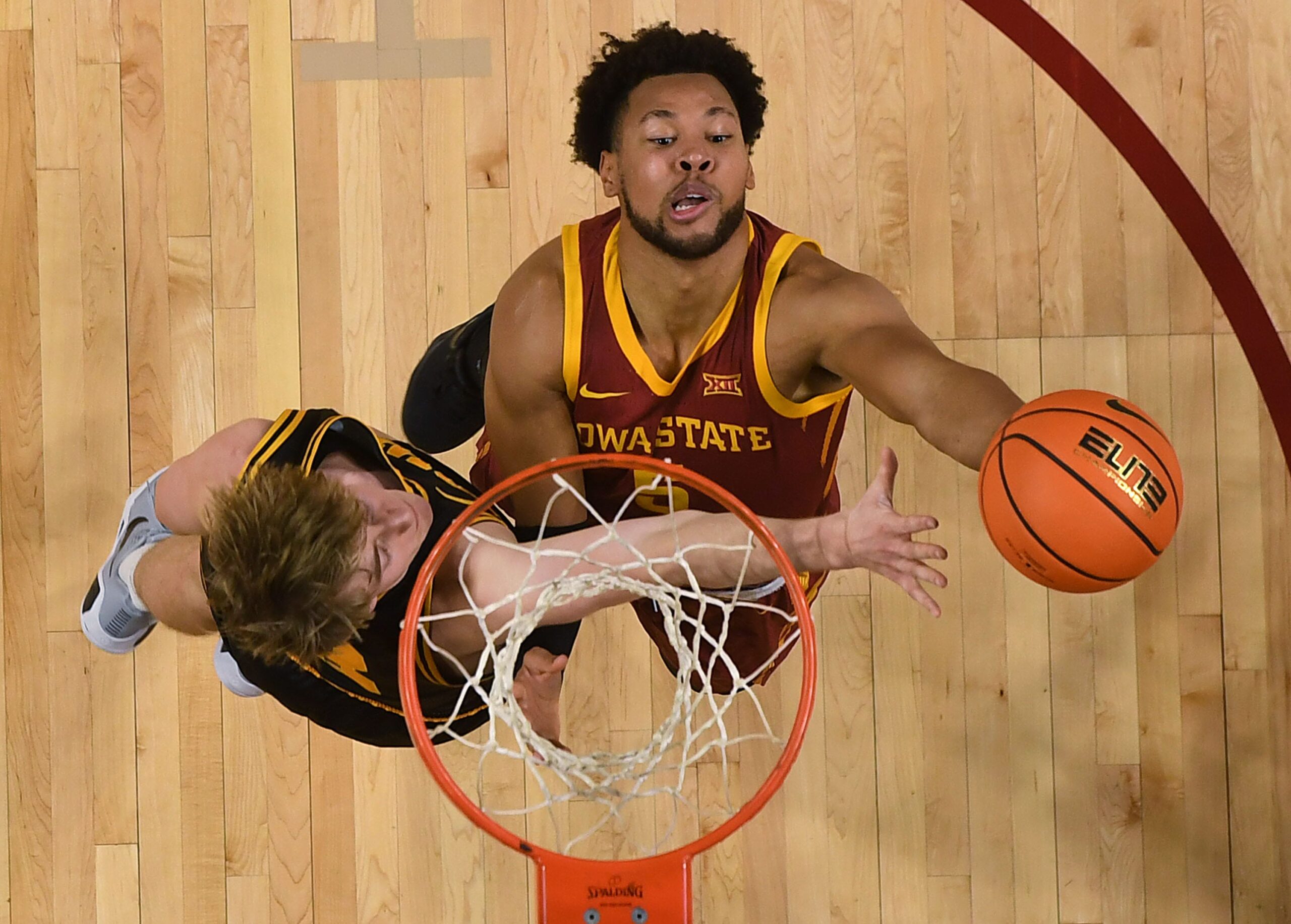 Iowa State Cyclones forward Joshua Jefferson (5) goes for a layup around Iowa Hawkeyes forward Cooper Koch (8) during the first half in the men’s basketball Cy-Hawk series on Dec. 11, 2025, in Ames, Iowa.