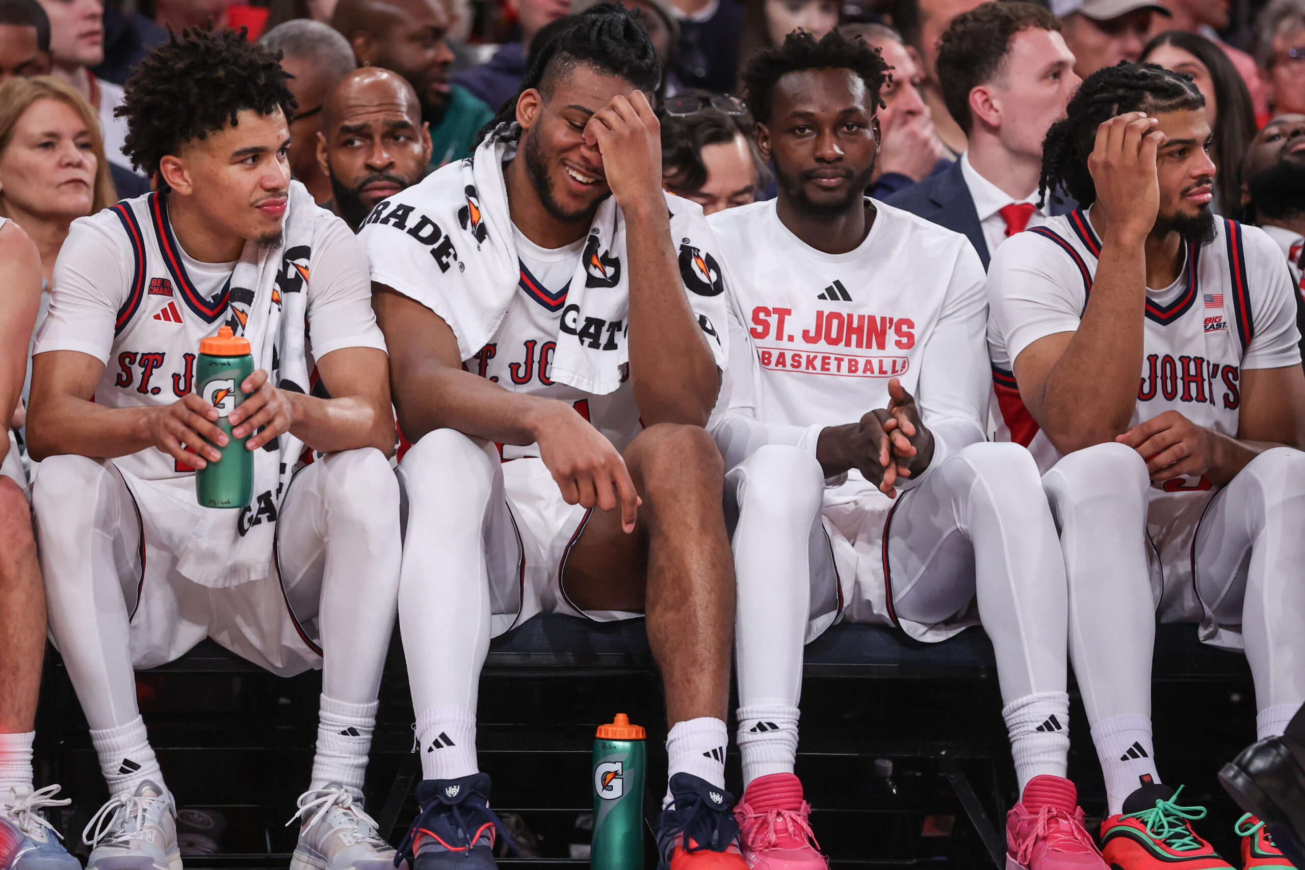 Dec 13, 2025; Queens, New York, USA;  St. John's Red Storm guard Oziyah Sellers (4), forwards Zuby Ejiofor (24), Sadiku Ibine Ayo (2) and Bryce Hopkins (23) sit on the bench in the second half against the Iona Gaels at Madison Square Garden. Mandatory Credit: Wendell Cruz-Imagn Images
