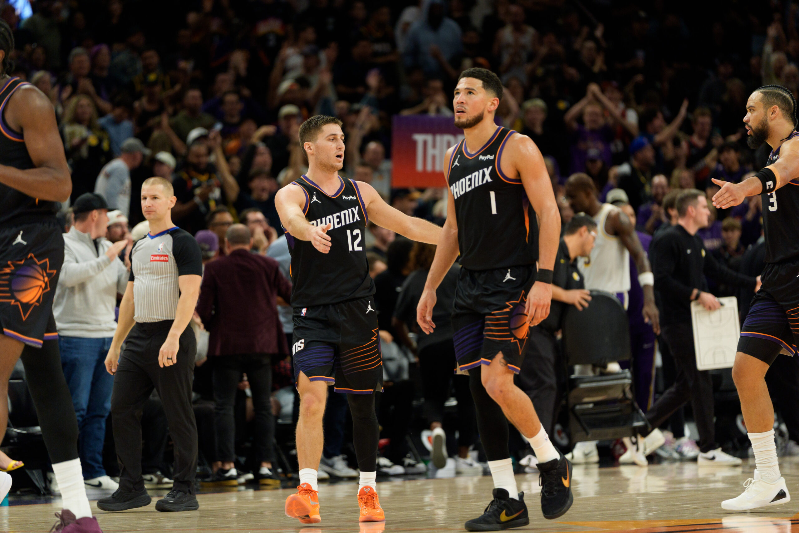 Dec 14, 2025; Phoenix, Arizona, USA; Phoenix Suns guard Devin Booker (1) and guard Collin Gillespie (12) react after the Sun take the lead late in the second half of a game against the Los Angeles Lakers at Mortgage Matchup Center. Mandatory Credit: Allan Henry-Imagn Images