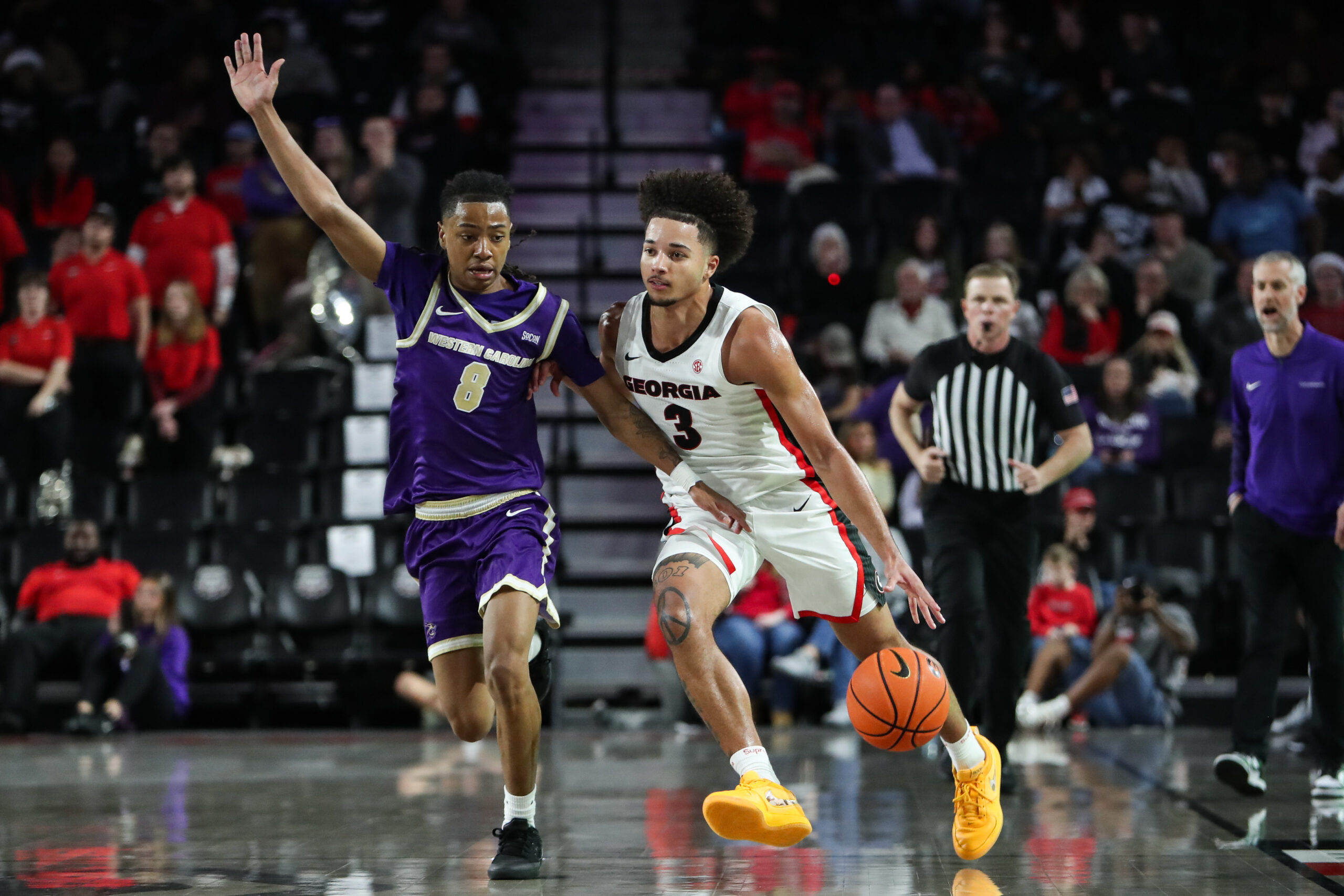 Dec 18, 2025; Athens, Georgia, USA; Georgia Bulldogs guard Jordan Ross (3) dribbles past Western Carolina Catamounts guard Tahlan Pettway (8) in the second half at Stegeman Coliseum. Mandatory Credit: Mady Mertens-Imagn Images