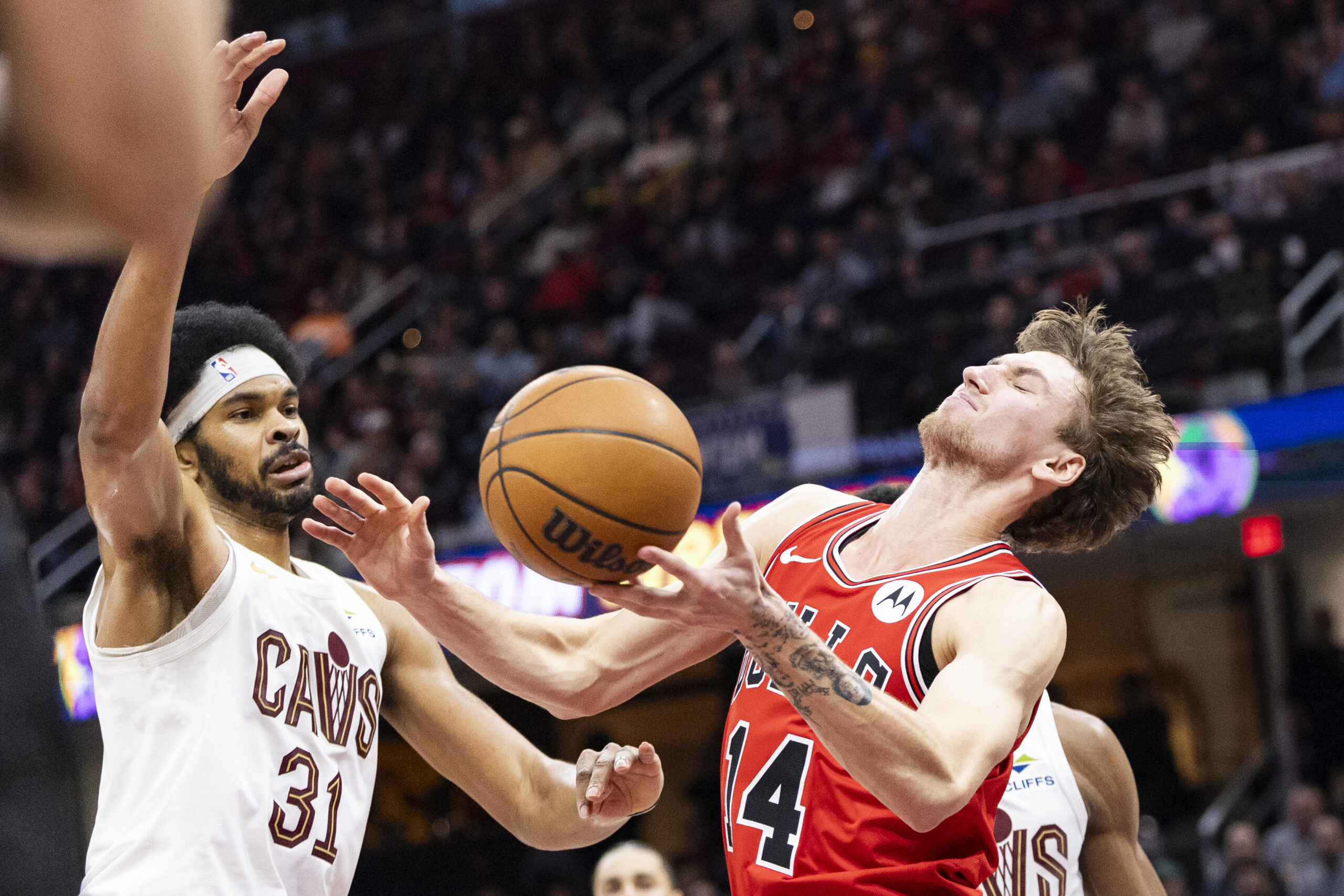 Dec 19, 2025; Cleveland, Ohio, USA; Chicago Bulls forward Matas Buzelis (14) loses the ball against Cleveland Cavaliers center Jarrett Allen (31) during the third quarter at Rocket Arena. Mandatory Credit: Scott Galvin-Imagn Images