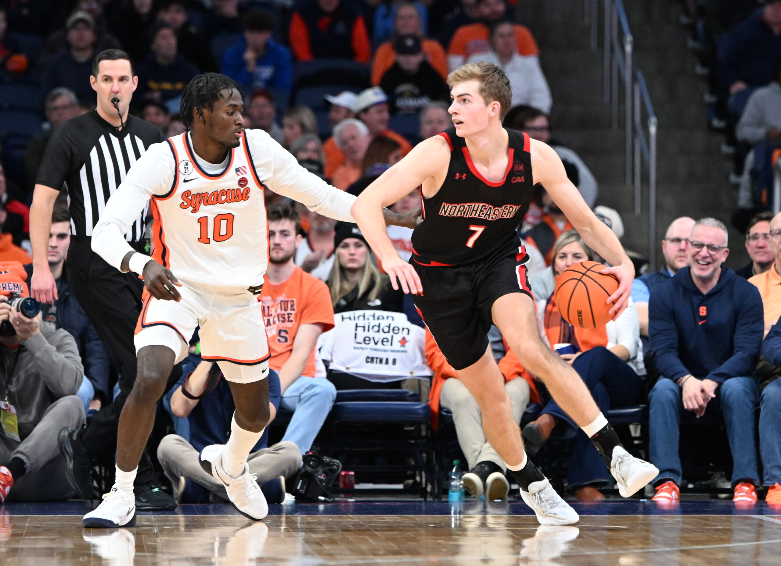 Dec 20, 2025; Syracuse, New York, USA; Northeastern Huskies forward Youri Fritz (7) handles the ball against Syracuse Orange forward Ibrahim Souare (10) in the second half at the JMA Wireless Dome. Mandatory Credit: Mark Konezny-Imagn Images