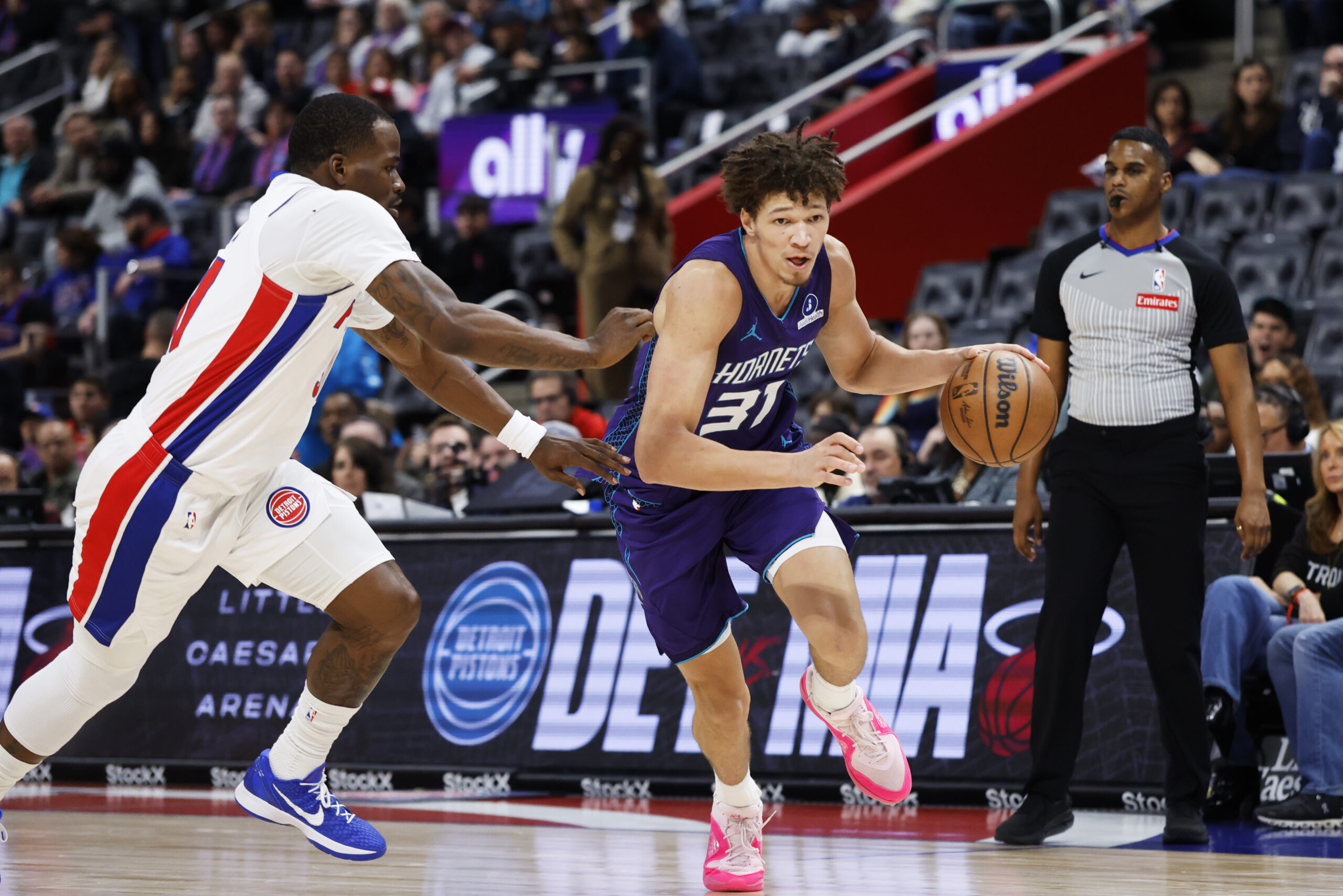 Dec 20, 2025; Detroit, Michigan, USA; Charlotte Hornets forward Tidjane Salaun (31) dribbles defended by Detroit Pistons guard Javonte Green (31) in the second half at Little Caesars Arena. Mandatory Credit: Rick Osentoski-Imagn Images