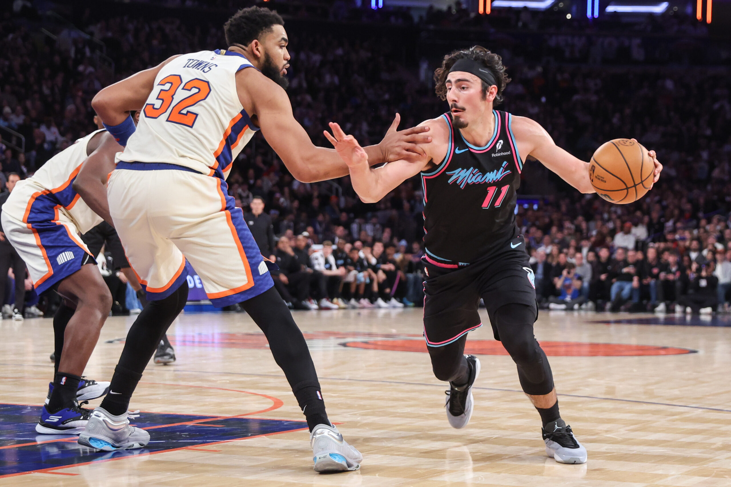 Dec 21, 2025; New York, New York, USA;  Miami Heat forward Jaime Jaquez Jr. (11) looks to drive past New York Knicks center Karl-Anthony Towns (32) in the fourth quarter at Madison Square Garden. Mandatory Credit: Wendell Cruz-Imagn Images