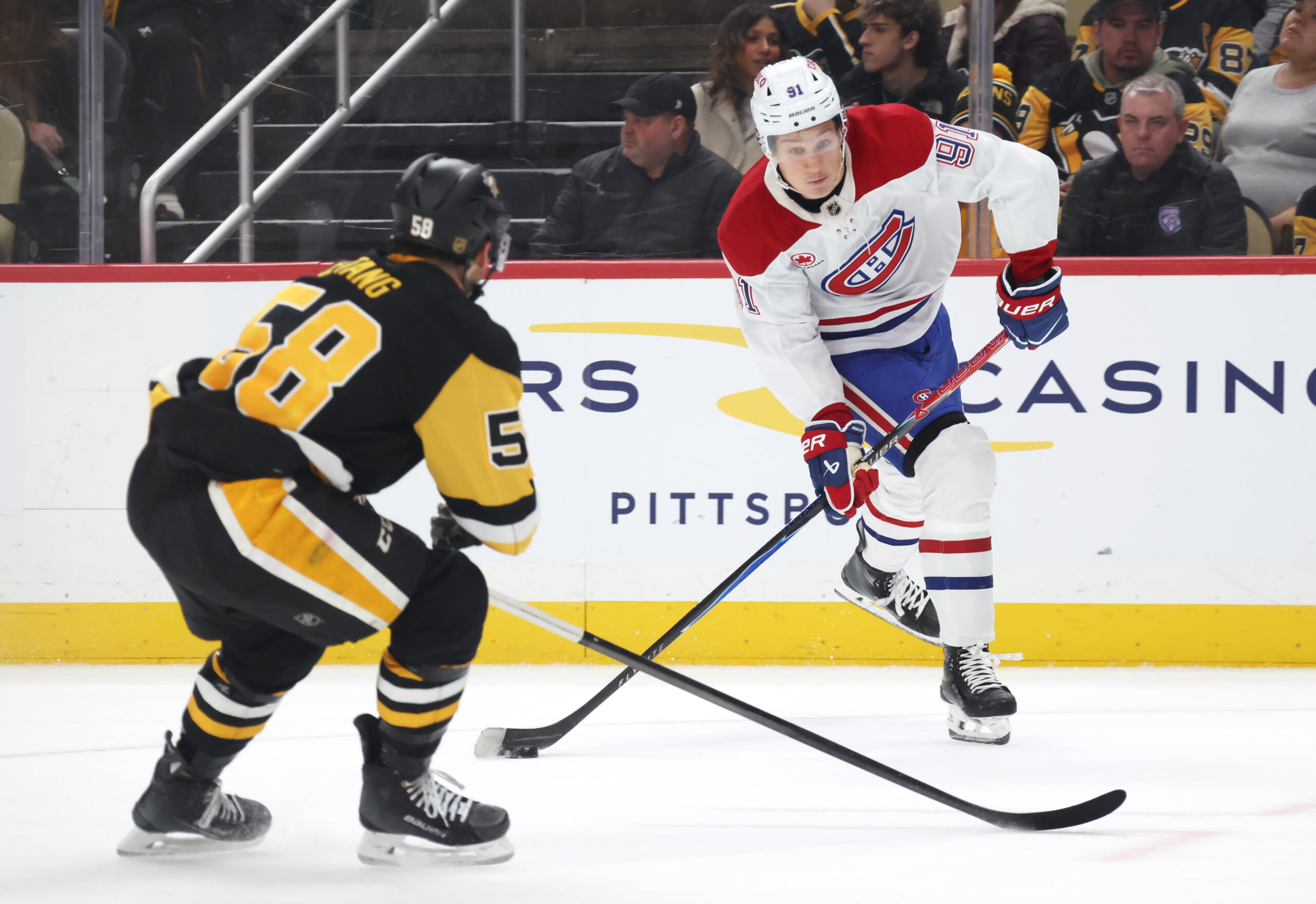 Dec 21, 2025; Pittsburgh, Pennsylvania, USA;  Montréal Canadiens center Oliver Kapanen (91) shoots the puck as Pittsburgh Penguins defenseman Kris Letang (58) defends during the second period at PPG Paints Arena. Mandatory Credit: Charles LeClaire-Imagn Images