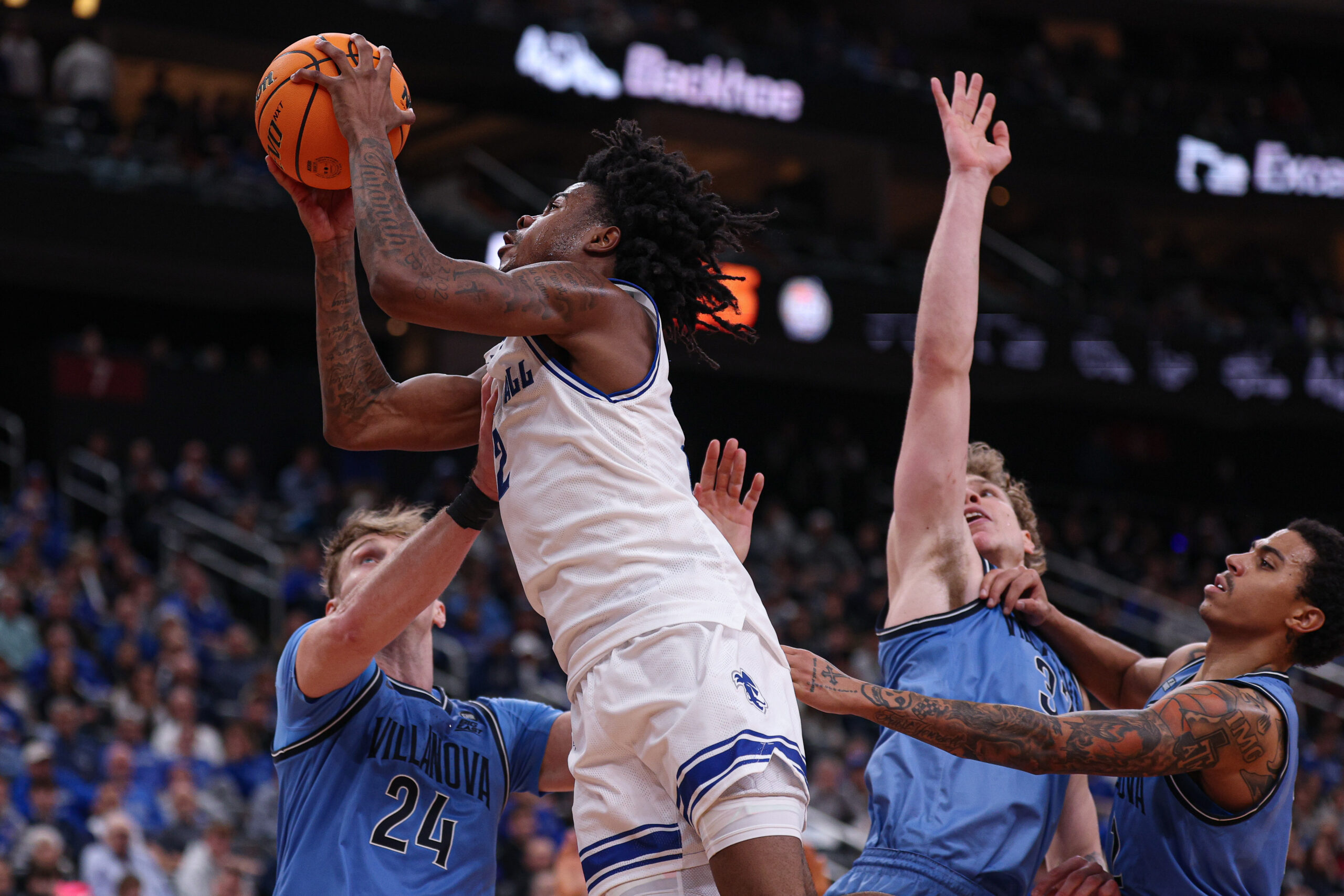 Dec 23, 2025; Newark, New Jersey, USA; Seton Hall Pirates guard Tajuan Simpkins (2) goes to the basket against Villanova Wildcats forward Duke Brennan (24) during the second half at Prudential Center. Mandatory Credit: Vincent Carchietta-Imagn Images
