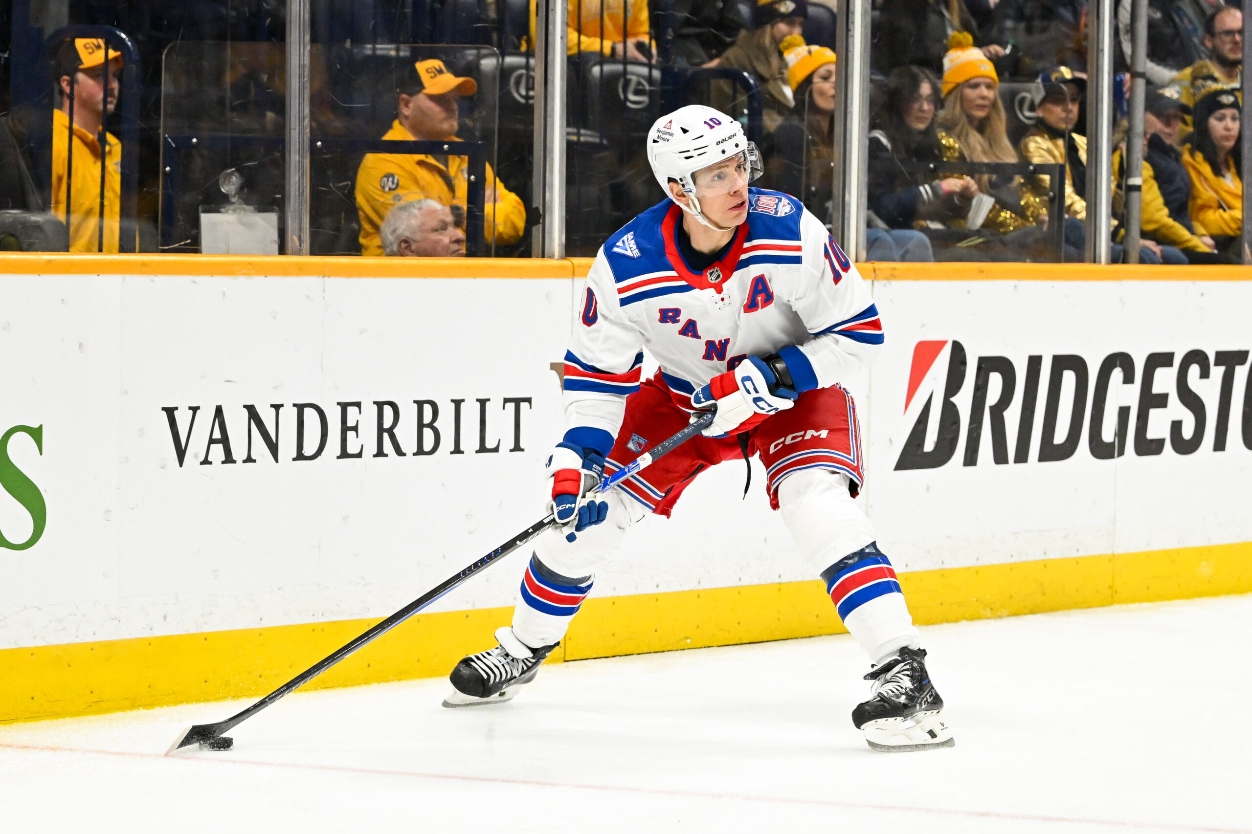 Dec 21, 2025; Nashville, Tennessee, USA;  New York Rangers left wing Artemi Panarin (10) skates behind the net against the Nashville Predators during the second period at Bridgestone Arena. Mandatory Credit: Steve Roberts-Imagn Images