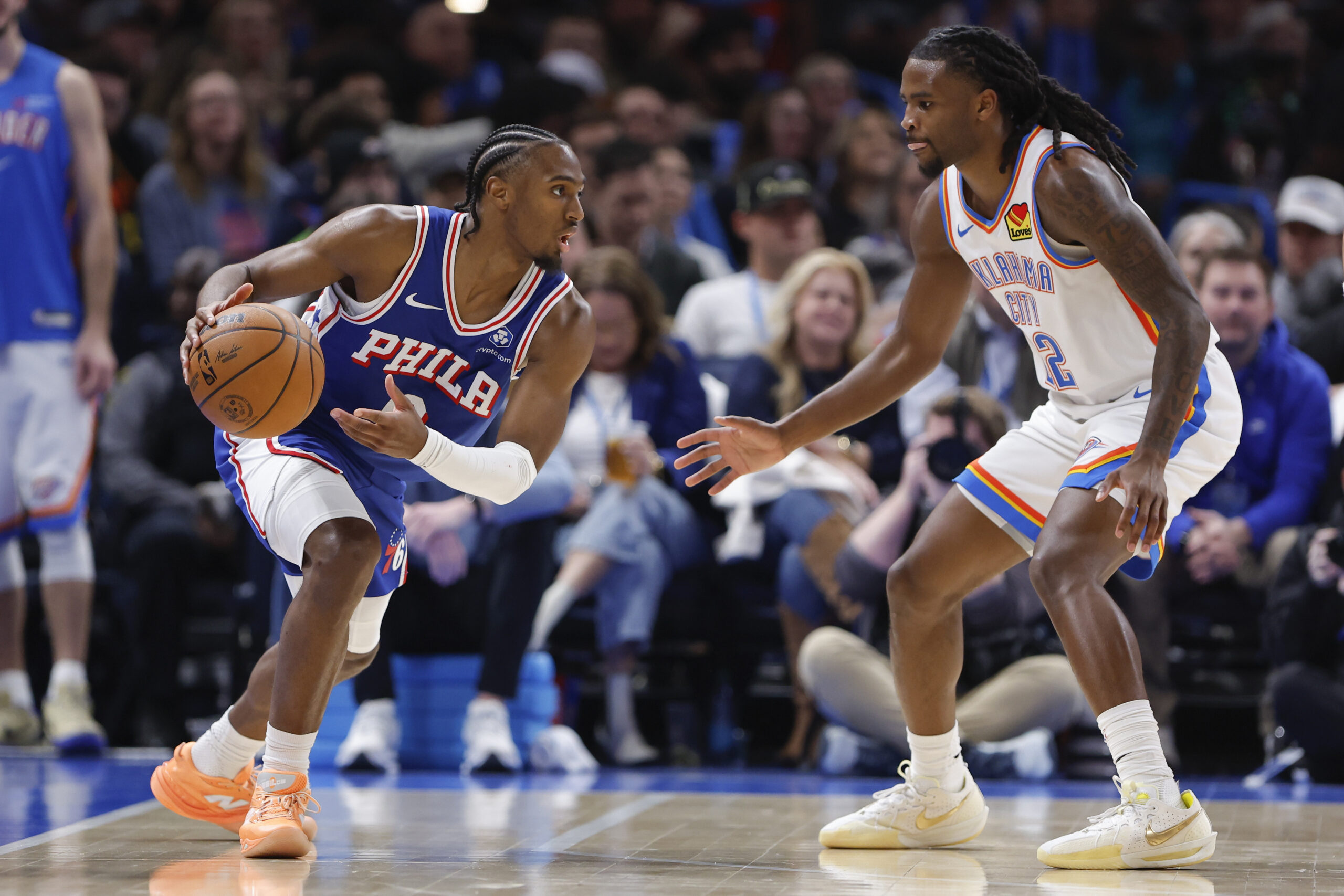 Dec 28, 2025; Oklahoma City, Oklahoma, USA; Philadelphia 76ers guard Tyrese Maxey (0) drives against Oklahoma City Thunder guard Cason Wallace (22) during the second half at Paycom Center. Mandatory Credit: Alonzo Adams-Imagn Images