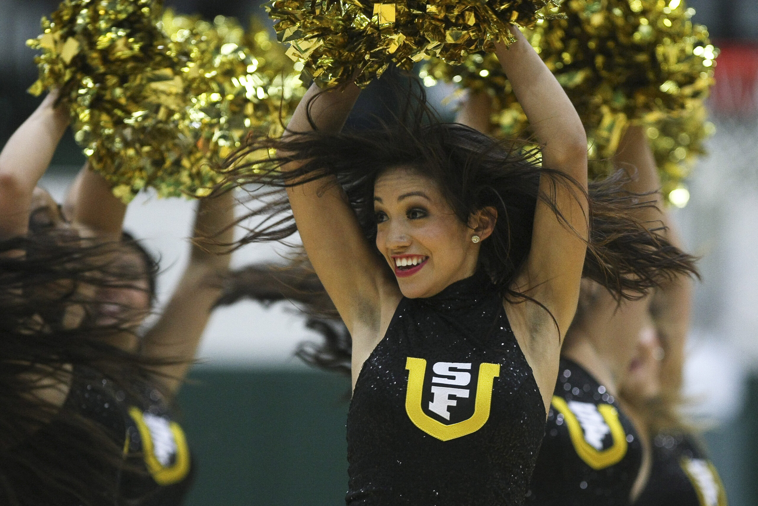 Dec 4, 2012; San Francisco, CA, USA; San Francisco Dons cheerleader performs against the St. John's Red Storm during the second half at Memorial Gymnasium.   The San Francisco Dons defeated the St. John's Red Storm 81-65. Mandatory Credit: Kelley L Cox-Imagn Images