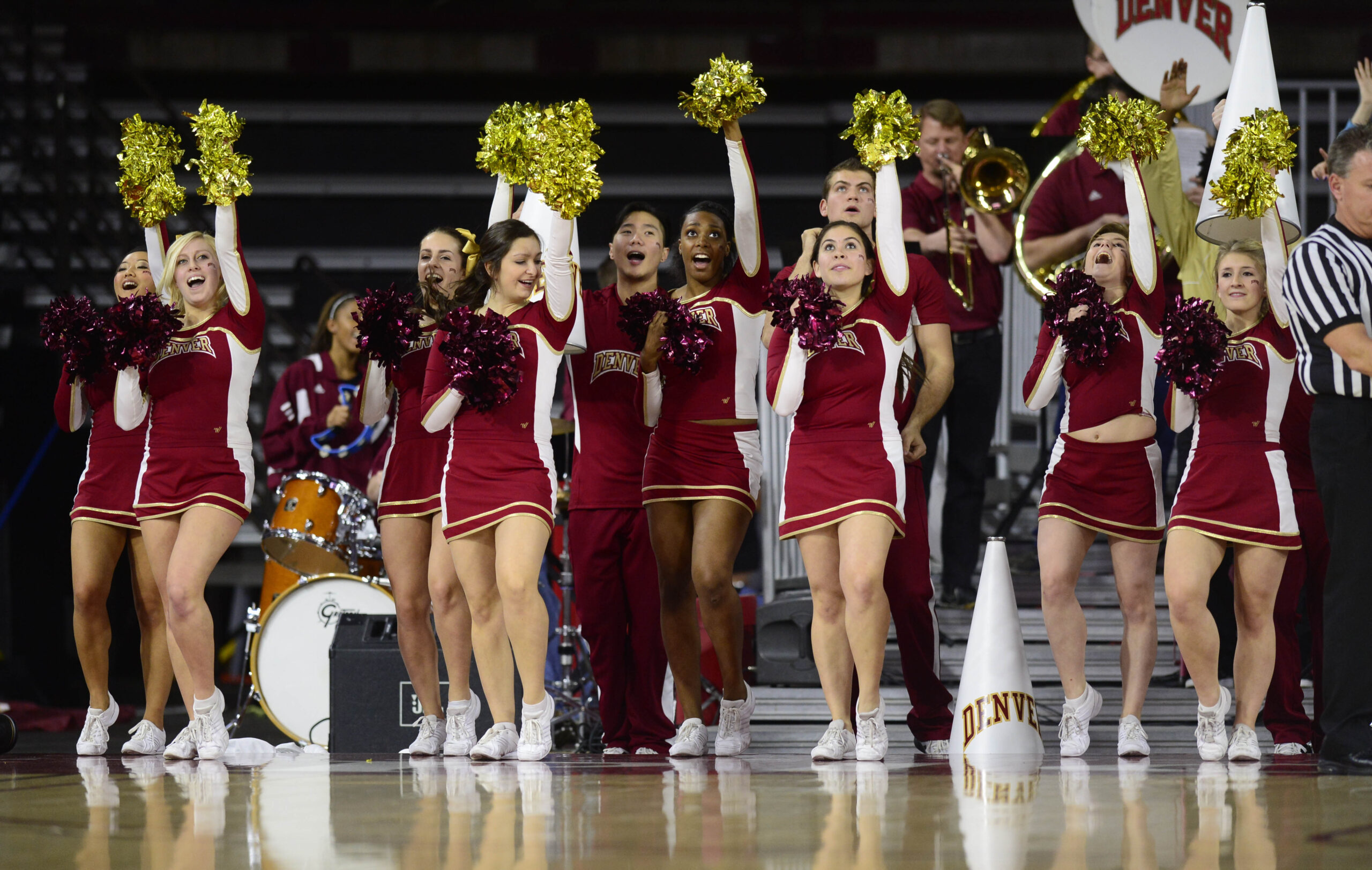 Dec 19, 2014; Denver, CO, USA; Denver Pioneers cheerleaders perform on the sidelines in the first half against the Colorado State Rams at Magness Arena. Mandatory Credit: Ron Chenoy-Imagn Images