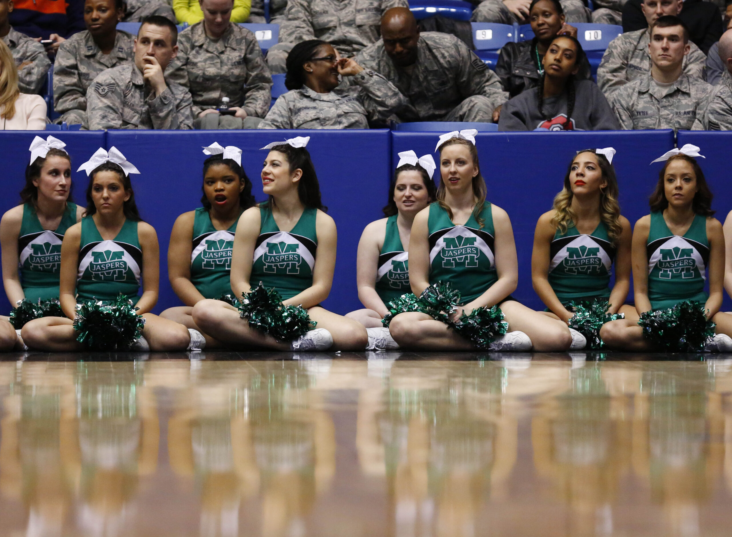 Mar 17, 2015; Dayton, OH, USA; Manhattan Jaspers cheerleaders sit court side during the first half against the Hampton Pirates in the first round of the 2015 NCAA Tournament at UD Arena. Mandatory Credit: Rick Osentoski-Imagn Images