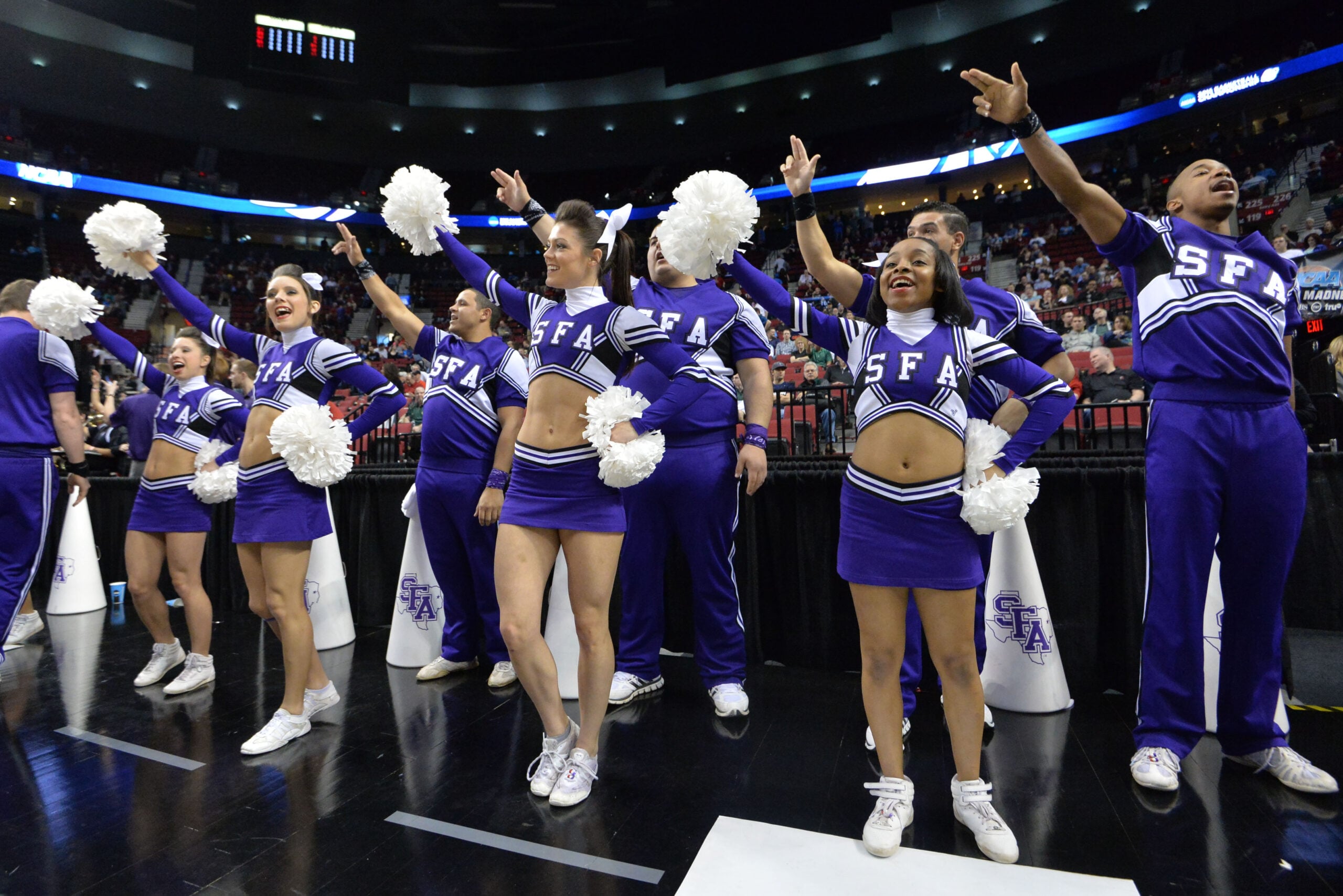 Mar 19, 2015; Portland, OR, USA; Stephen F. Austin Lumberjacks cheerleaders perform against the Utah Utes during the first half in the second round of the 2015 NCAA Tournament at Moda Center. Mandatory Credit: Kirby Lee-Imagn Images