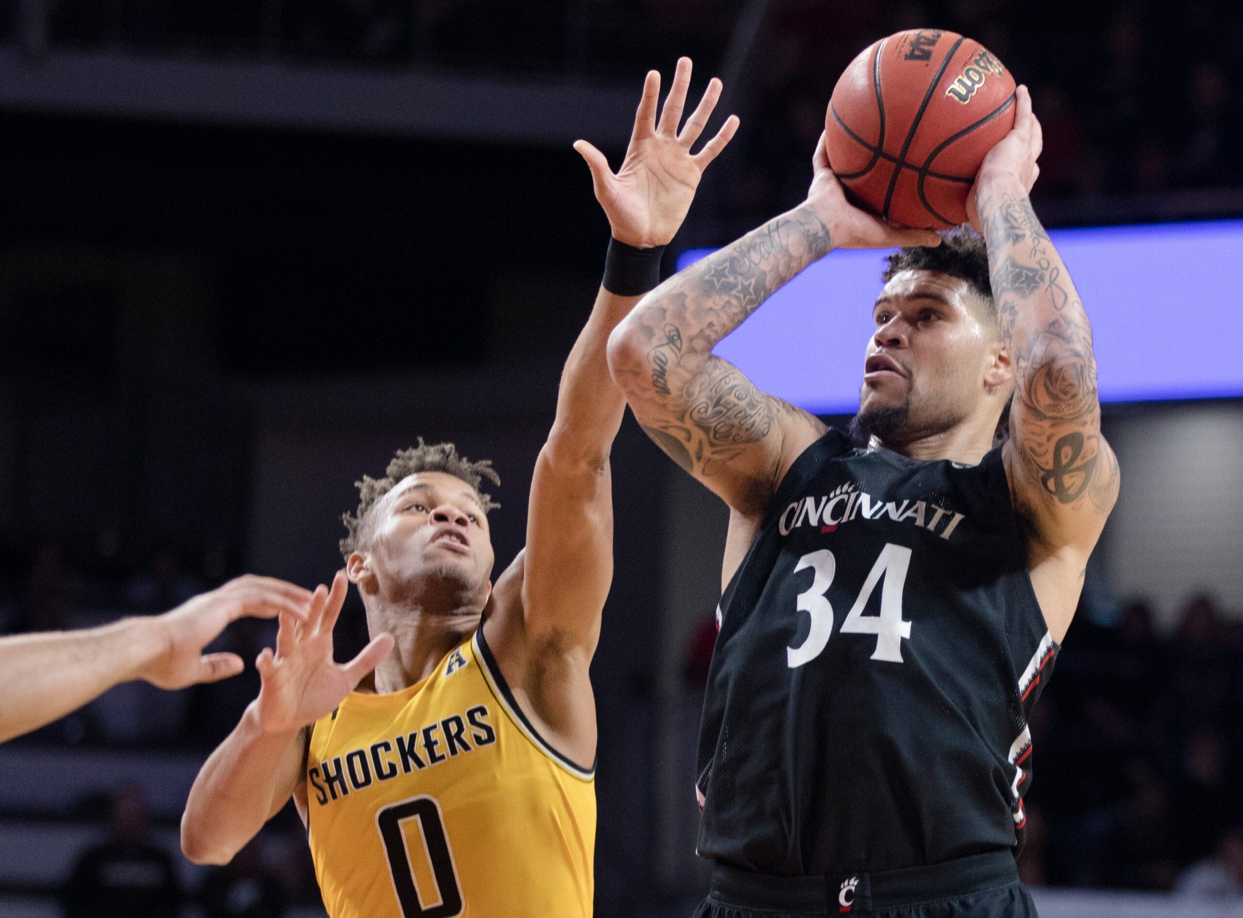 Cincinnati Bearcats guard Jarron Cumberland (34) shoots as Wichita State Shockers guard Dexter Dennis (0) guards in the second half of the NCAA men's basketball game on Sunday, Feb. 23, 2020, in Fifth Third Arena at the University of Cincinnati. Cincinnati Bearcats defeated Wichita State Shockers 67-64.

Cincinnati Bearcats Wichita State Shockers 256