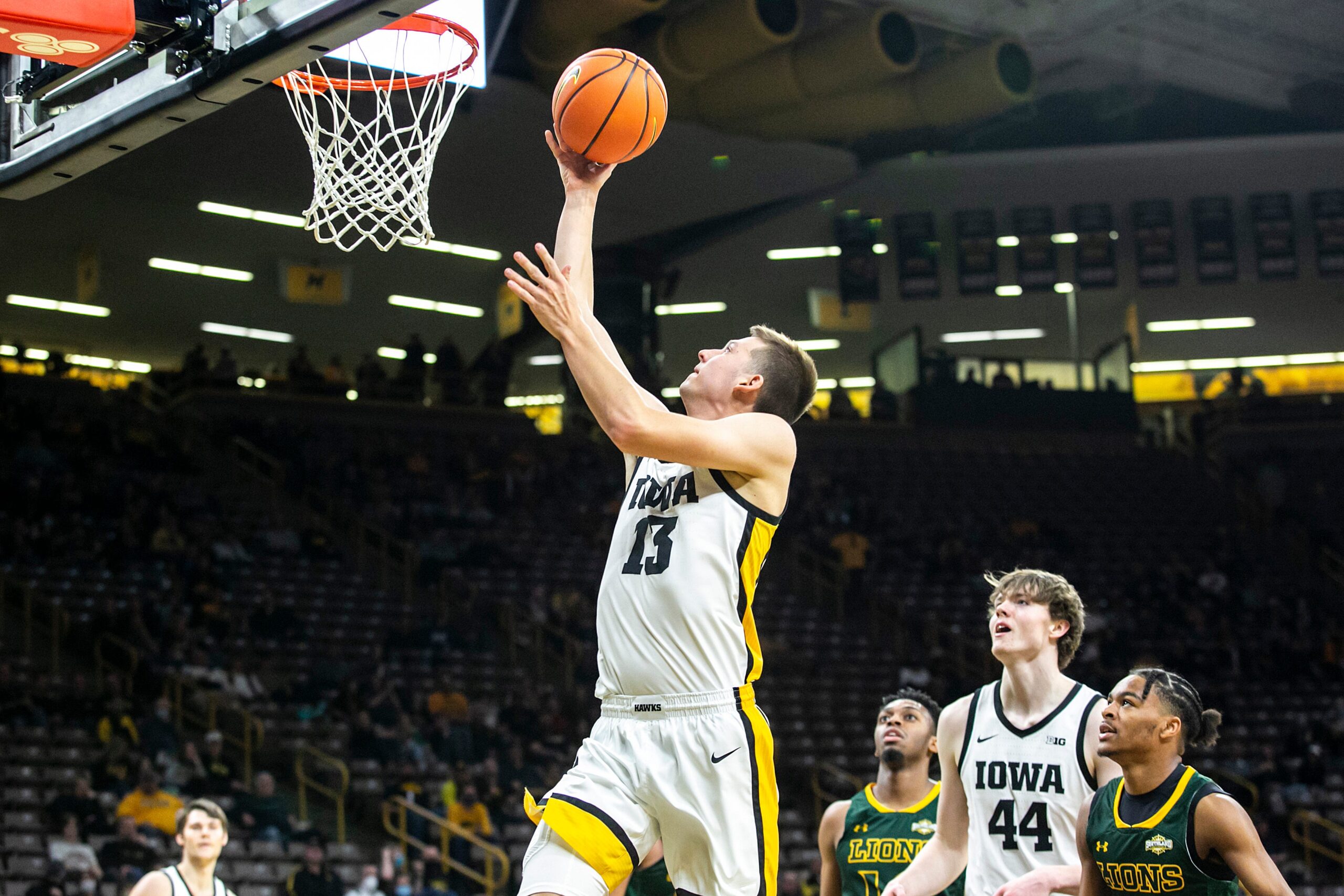 Iowa guard Austin Ash (13) makes a basket during a NCAA non-conference men's basketball game against Southeastern Louisiana, Tuesday, Dec. 21, 2021, at Carver-Hawkeye Arena in Iowa City, Iowa.

211221 Se Louisiana Iowa Mbb 037 Jpg