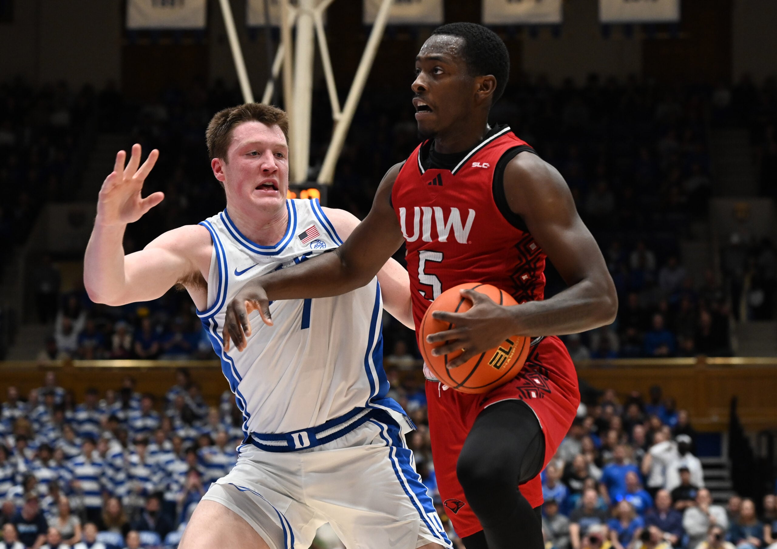 Dec 10, 2024; Durham, North Carolina, USA;  dIncarnate Word Cardinals guard Davion Bailey (5) drives to the basket as Duke Blue Devils forward Kon Knueppel (7) defends during the first half at Cameron Indoor Stadium. Mandatory Credit: Rob Kinnan-Imagn Images