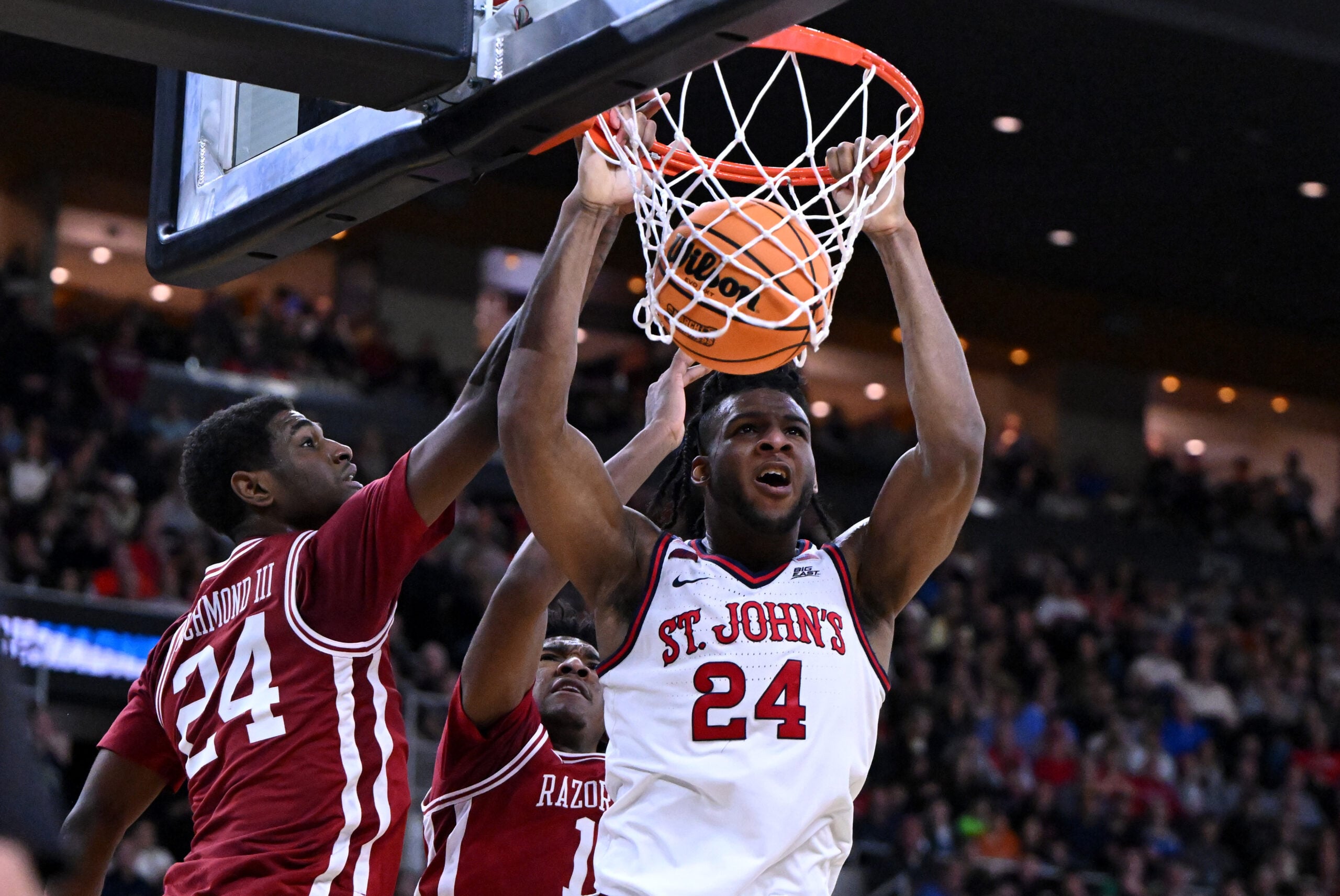 Mar 22, 2025; Providence, RI, USA; St. John's Red Storm forward Zuby Ejiofor (24) dunks against Arkansas Razorbacks forward Billy Richmond III (24) and guard Johnell Davis (1) during the second half of a second round men’s NCAA Tournament game at Amica Mutual Pavilion. Mandatory Credit: Brian Fluharty-Imagn Images