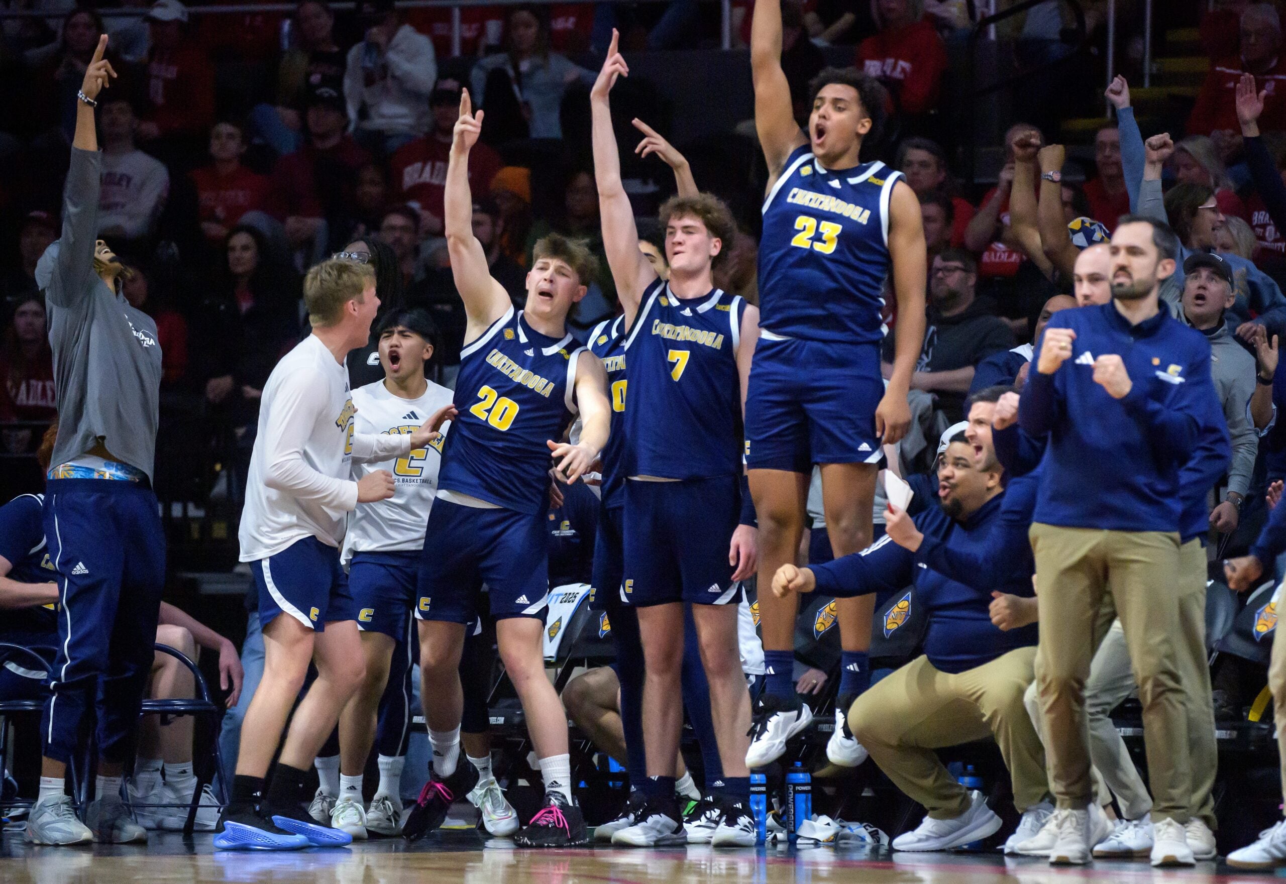 The Chattanooga bench erupts after a three-pointer gives them the lead over Bradley in the second half of their NIT quarterfinal basketball game Tuesday, March 25, 2025 at Carver Arena in Peoria. The Mocs advanced to the semifinals with a 67-65 win.