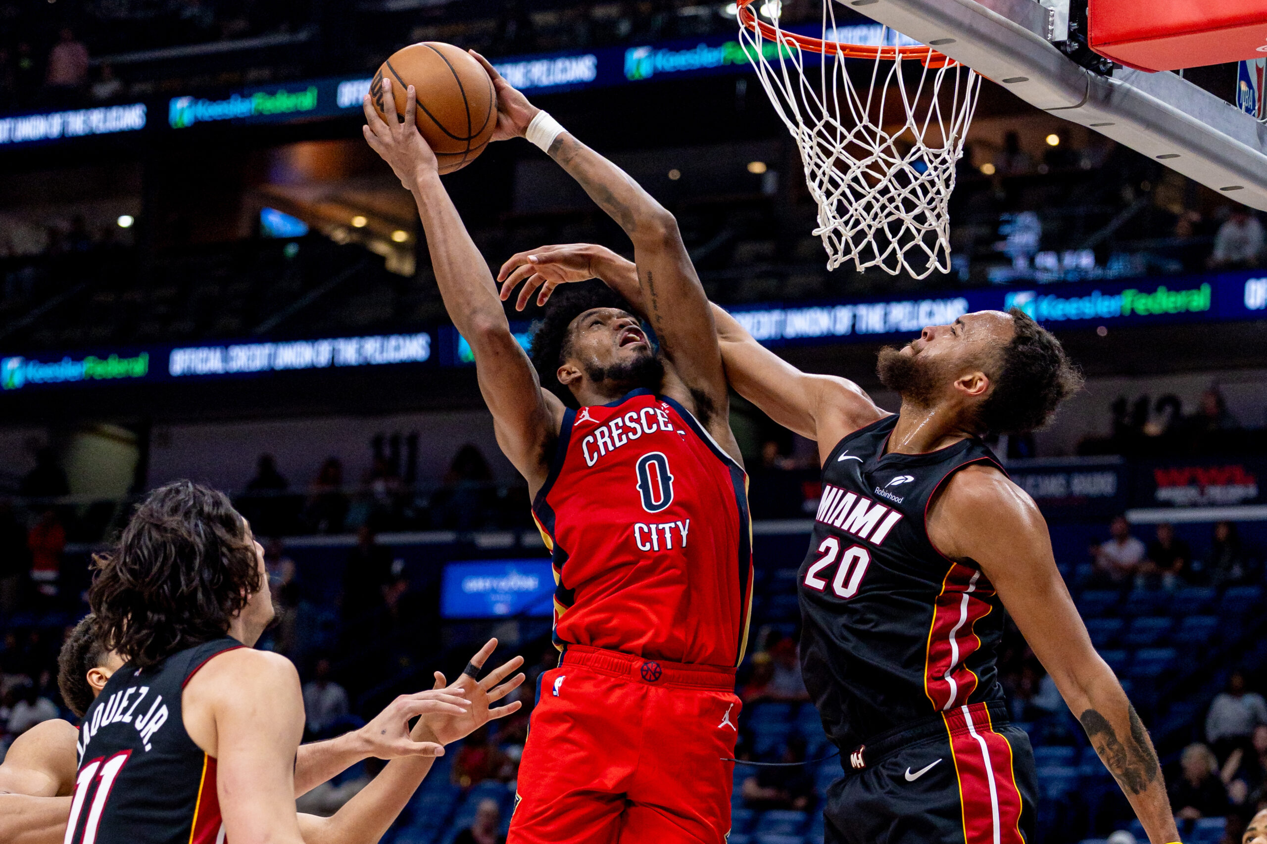 Apr 11, 2025; New Orleans, Louisiana, USA;  Miami Heat forward Kyle Anderson (20) fouls New Orleans Pelicans forward Keion Brooks Jr. (0) during the second half at Smoothie King Center. Mandatory Credit: Stephen Lew-Imagn Images