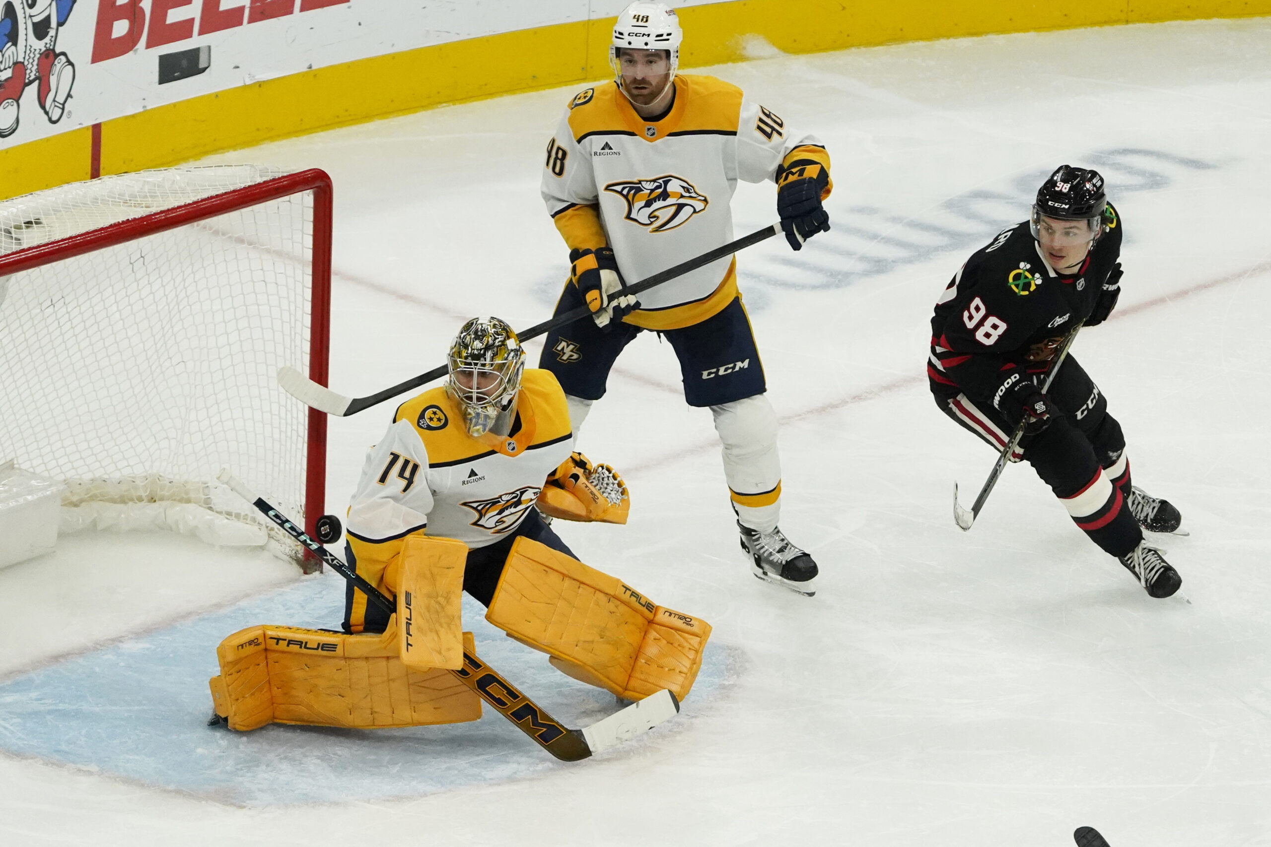 Nov 28, 2025; Chicago, Illinois, USA; Nashville Predators goaltender Juuse Saros (74) makes a save as Chicago Blackhawks center Connor Bedard (98) follows the puck Nashville Predators goaltender Juuse Saros (74) during the third period at United Center. Mandatory Credit: David Banks-Imagn Images
