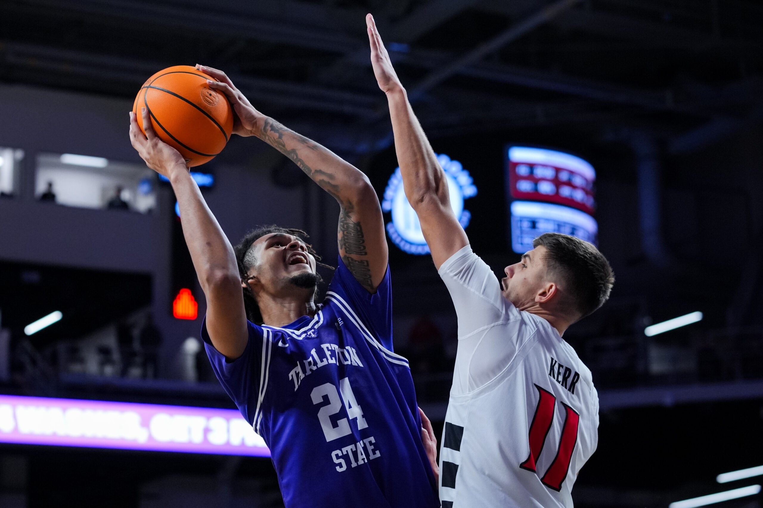 Dec 1, 2025; Cincinnati, Ohio, USA;  Tarleton State Texans forward Ocypher Owens (24) drives to the basket against Cincinnati Bearcats guard Kerr Kriisa (11) in the second half at Fifth Third Arena. Mandatory Credit: Aaron Doster-Imagn Images